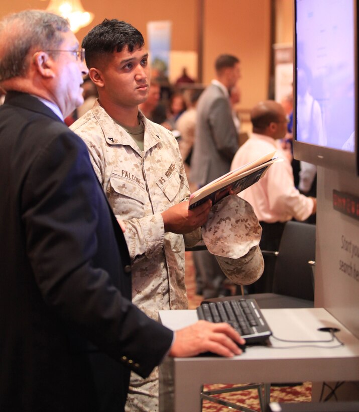 Camp Pendleton, CA - Sam Giovinazzi, an administrative support technician with the California Employers Support Guard and Reserve, assists Lance Cpl. Nikko Falcon, a generator mechanic with 1st Intelligence Battalion, I Marine Expeditionary Force Headquarters Group, with a job search during a Hiring Our Heroes Veterans Event hosted by the U.S. Chamber of Commerce at the Pacific Views South Mesa Club here, Sept. 20. The chamber partnered with the State of California Employment Development Department, the Department of Veterans Affairs, the American Legion, the Department of Labor Veterans’ Employment & Training Services, the California National Guard and Camp Pendleton Marine Corps Community Services to put on the event. 