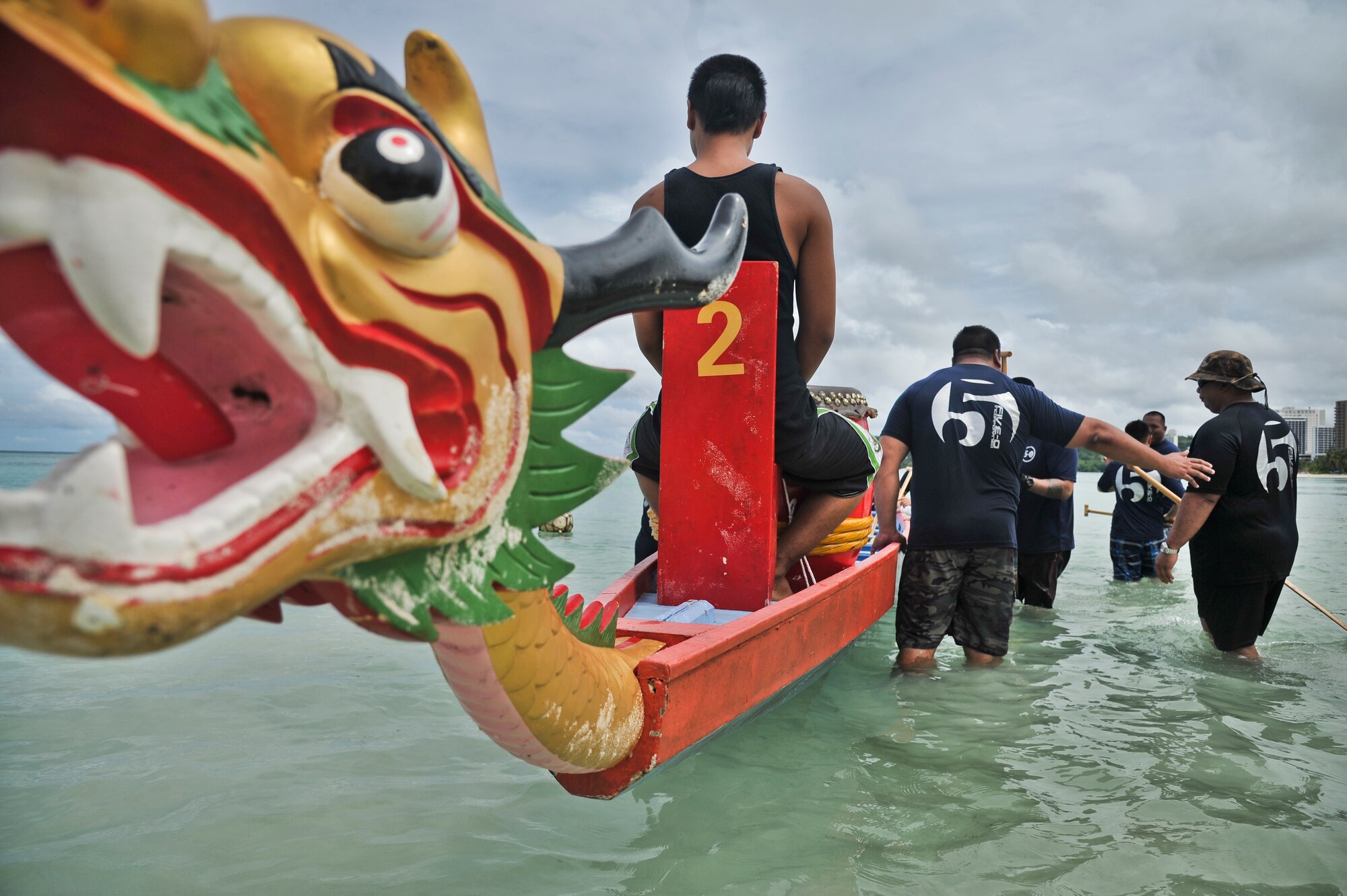 TAMUNING, Guam—Dragon Boat crew members from the Navy Tag Five team load into their boat during the 2012 Second Annual 9/11 Commemorative Dragon Boat Race at Matapang Beach, Sept. 22. This year’s boat Race had 10 person teams including the Guam Police Department, Andersen and deployed-in Kadena AFB Fire Department Airman, Guam Fire Department, Guam National Guard, Naval Fire Department, Navy Tag Five and the Haggan Outrigger Canoe Club. The dragon boat race consisted of eight separate heats competing for time, with the Guam Police Department taking the overall win with 2:12.63 seconds. (U.S. Air Force photo by Staff Sgt. Alexandre Montes/Released)