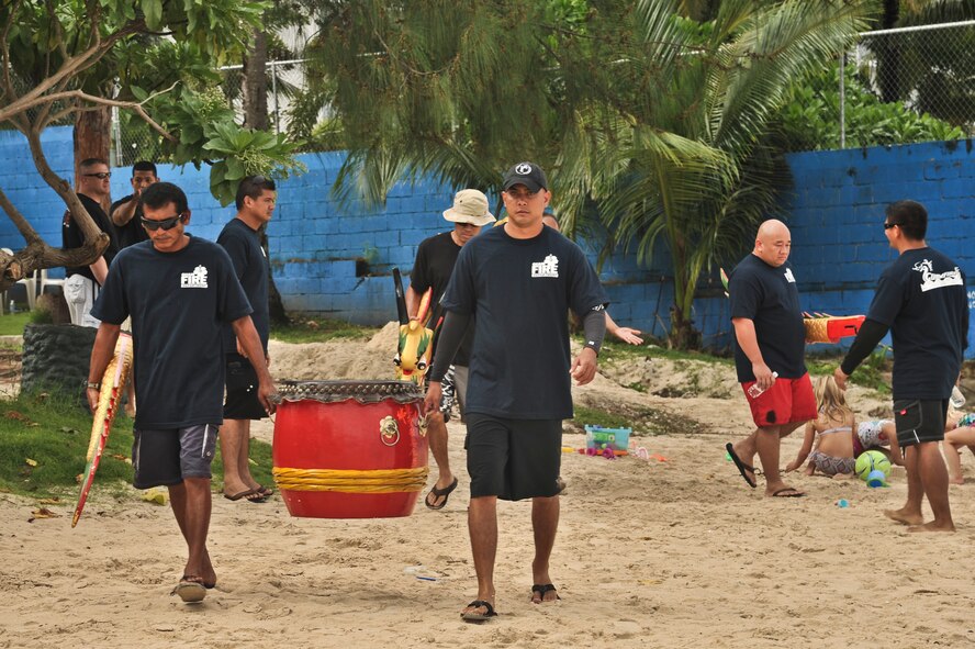 TAMUNING, Guam—Guam Police Department crew members bring out their drum to keep cadence on their dragon boat at the 2012 Second Annual 9/11 Commemorative Dragon Boat Race at Matapang Beach here, Sept. 22. This year’s boat race had ten-person teams that included personnel from the Guam Police Department, Andersen Air Force Base, deployed-in Kadena AFB Fire department, Guam Fire Department, Guam National Guard, Naval Fire Department, Navy Tag Five and the Haggan Outrigger Canoe Club. The dragon boat race consisted of eight separate heats, competing for time. The Guam Police Department took the overall win with 2:12.63 seconds. (U.S. Air Force photo by Staff Sgt. Alexandre Montes/Released)