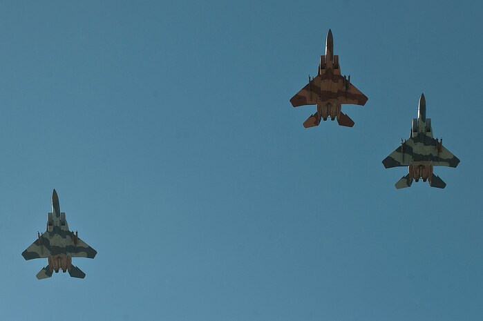 Three U.S. Air Force F-15 Eagles, 65th Aggressor Squadron, led by Capt Jonah "Snoozz" Brown, 65th AGRS pilot, conduct a Missing Man Formation flyover during a remembrance ceremony as part of  National POW/MIA Recognition Day Sept. 21, 2012, at Nellis Air Force Base, Nev. The remembrance ceremony consisted of the posting of the colors, the singing of the National Anthem, a POW/MIA Proclamation, a 21-gun salute, and a Missing Man Formation flyover. (U.S. Air Force photo by Staff Sgt. Christopher Hubenthal)