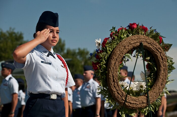 Meleny Mendoza, Reserve Officer Training Corps cadet, salutes the wreath during a remembrance ceremony as part of National POW/MIA Recognition Day Sept. 21, 2012, at Nellis Air Force Base, Nev. On the third Friday of September each year, Nellis AFB takes time to remember those who are missing in action, as well as their families, by holding the remembrance ceremony. (U.S. Air Force photo by Staff Sgt. Christopher Hubenthal)