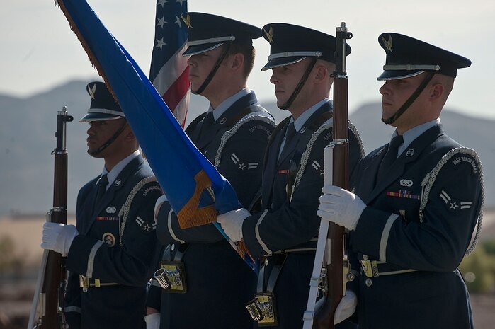Nellis Honor Guard members post the colors during a remembrance ceremony as part of National POW/MIA Recognition Day Sept. 21, 2012, at Nellis Air Force Base, Nev. The remembrance ceremony consisted of the posting of the colors, the singing of the National Anthem, a POW/MIA Proclamation, a 21-gun salute, and a Missing Man Formation flyover. (U.S. Air Force photo by Staff Sgt. Christopher Hubenthal)