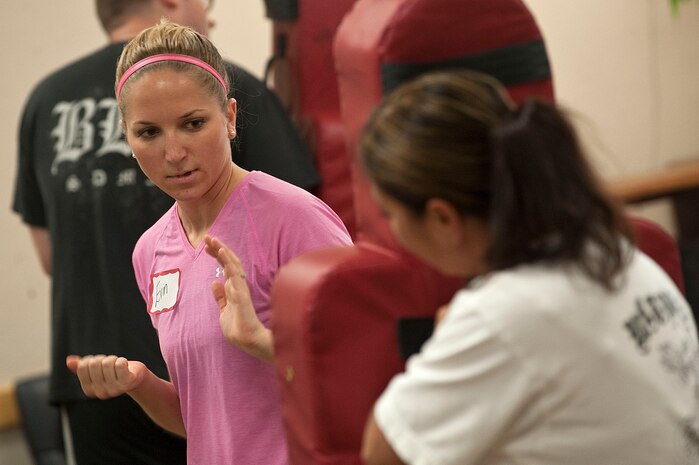 First Lt. Evin Greensfelder, 57th Aircraft Maintenance Squadron viper aircraft maintenance unit officer in charge, practices techniques with Master Sgt. Estafanie Wanous, 57th AMXS viper specialist section noncommissioned officer in charge, during a Rape Aggression Defense Systems class Sept. 18, 2012, at Nellis Air Force Base, Nev. Ten Airmen attended the three-day long course to become certified to teach the curriculum, designed to balance the needs of women to acquire self defense education in a short period of time.(U.S. Air Force photo by Staff Sgt. Christopher Hubenthal)
