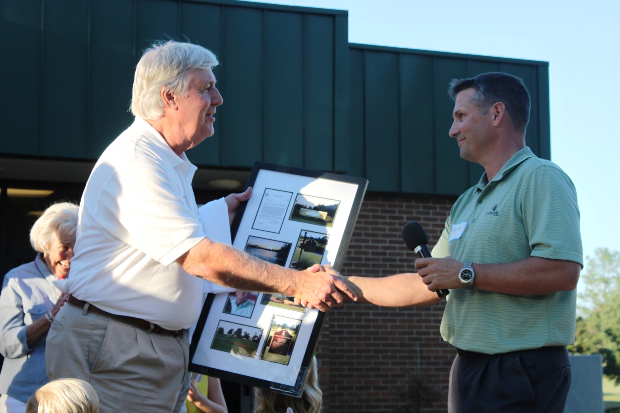 Stephen M. Creech, Sumter Chamber of Commerce Military Affairs chairman, shakes hands with Col. Clay Hall, 20th Fighter Wing commander, during a surprise dedication ceremony, where the golf course complex was renamed after him in his honor, Shaw Air Force Base, S.C., Sept. 24, 2012. Creech is a former City of Sumter Mayor and long time military supporter. Creech’s family and several local civic leaders attended the dedication ceremony. (U.S. Air Force photo by 1st Lt. Ann Blodzinski/Released)  
