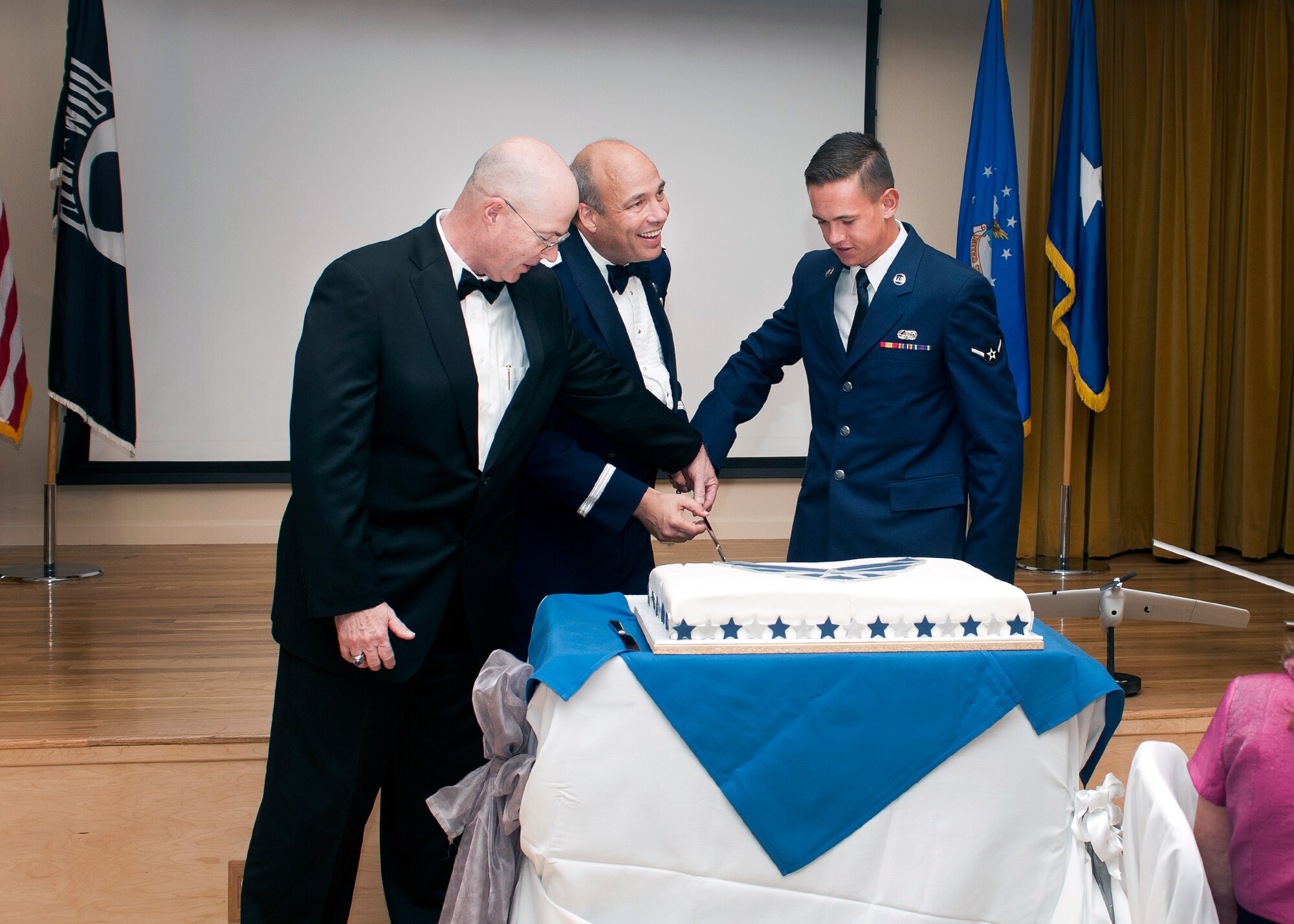 Sticking to tradition, Brig. Gen. Michael T. Brewer, 412th Test Wing commander, cuts the Air Force birthday cake with the youngest Airman in attendance, Airman Michael Day, 412th Communications Squadron. James Judkins, 412th Civil Engineering Division director, helps out. (U.S. Air Force photo by Ethan Wagner)