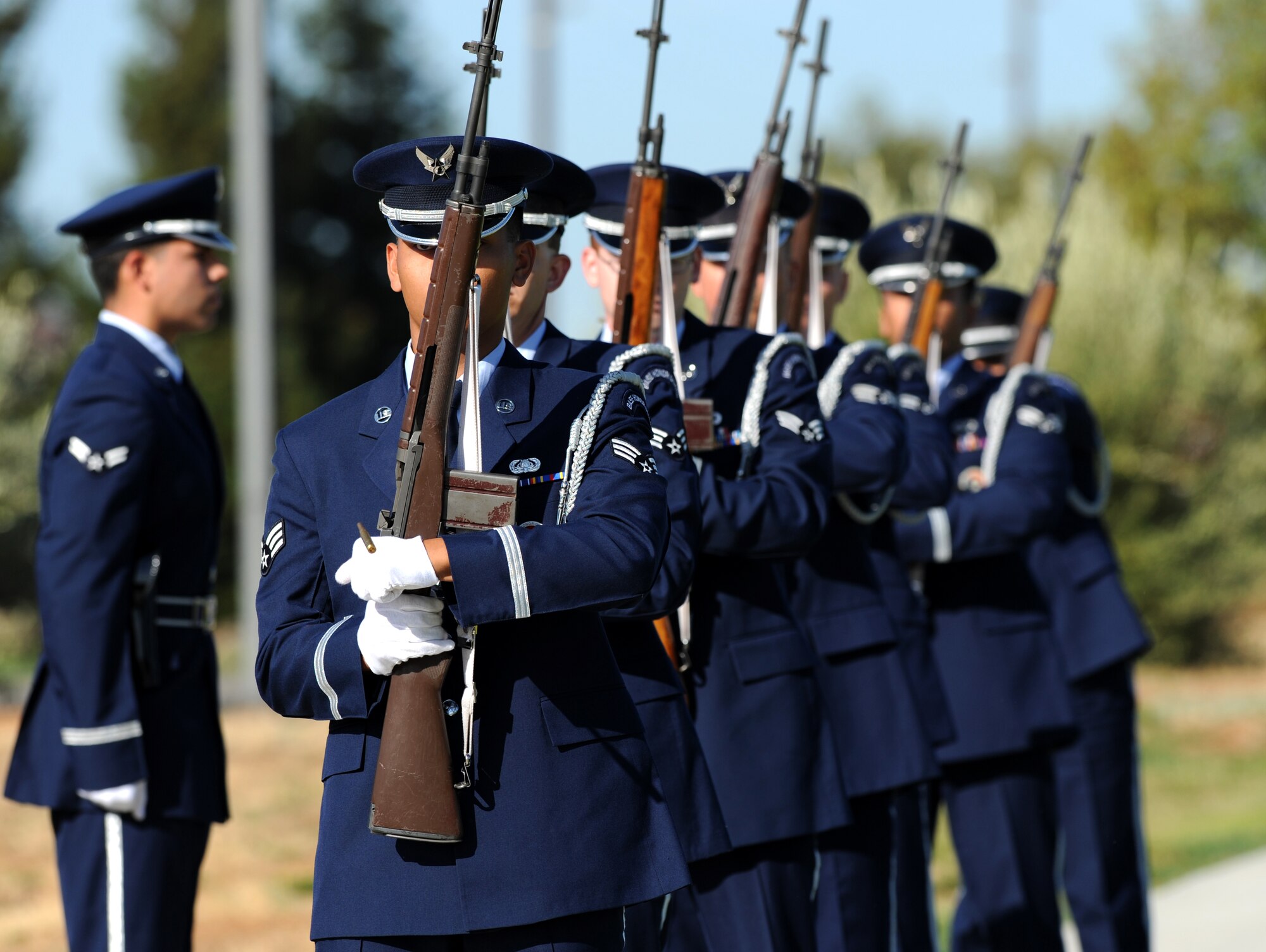 Members of Team Beale’s Honor Guard reload while performing a three shot volley at Heritage Park during a POW/MIA ceremony at Beale Air Force Base, Calif., Sept. 21, 2012. The three-volley salute is a ceremonial act performed at military and police funerals or memorial ceremonies. (U.S. Air Force photo by Staff Sgt. Robert M. Trujillo/Released)