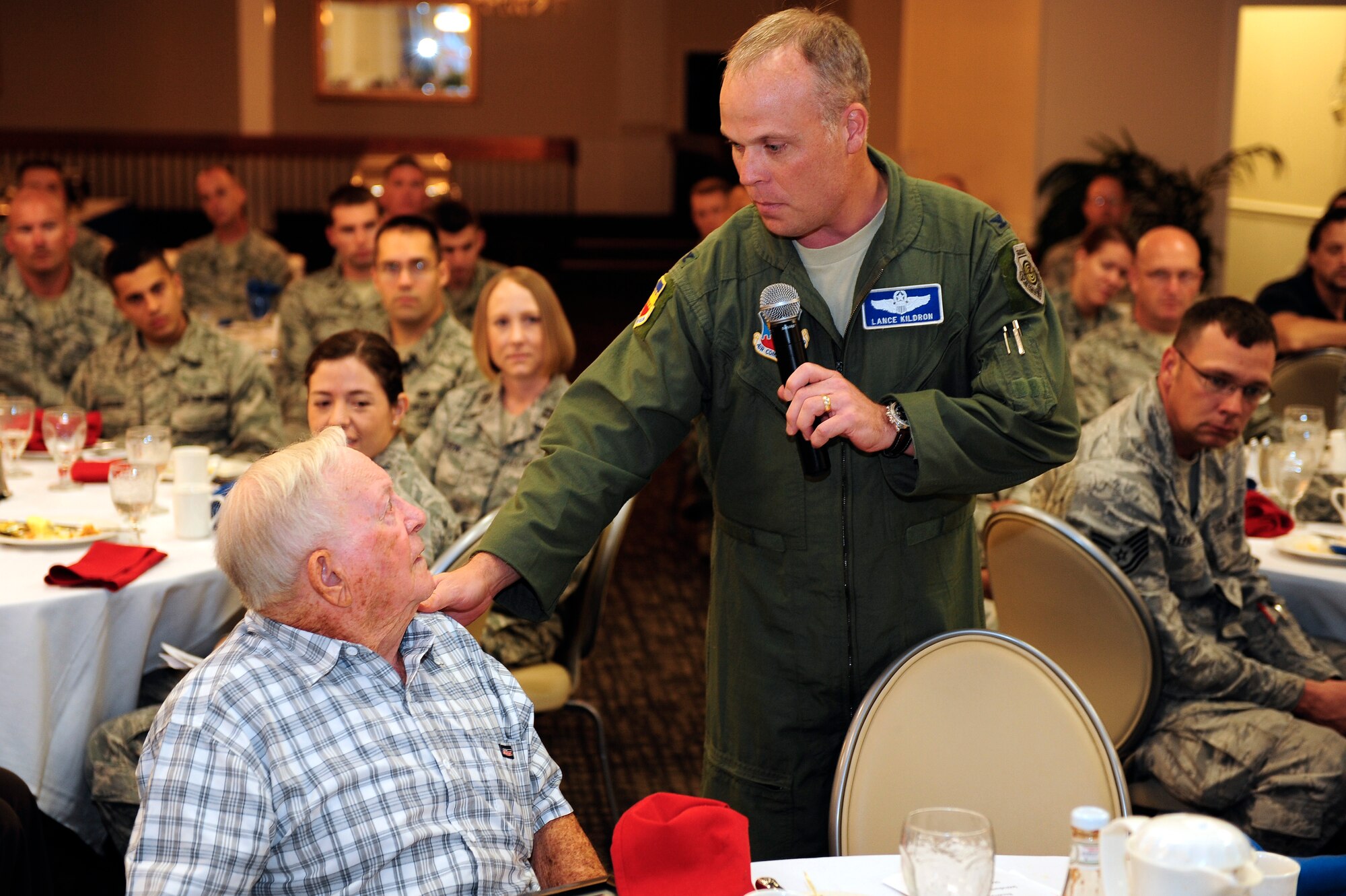 Col. Lance Kildron, 20th Fighter Wing vice commander, extends a heartfelt thank you to guest speaker, and former prisoner of war retired Senior Master Sgt. Kenneth Duffy during the prisoner of war and missing in action breakfast. Kildron also presented Duffy with a coin as a gesture of gratitude for him speaking during the ceremony and sharing his story with Team Shaw. (U.S. Air Force photo by Airman 1st Class Daniel Blackwell/Released)