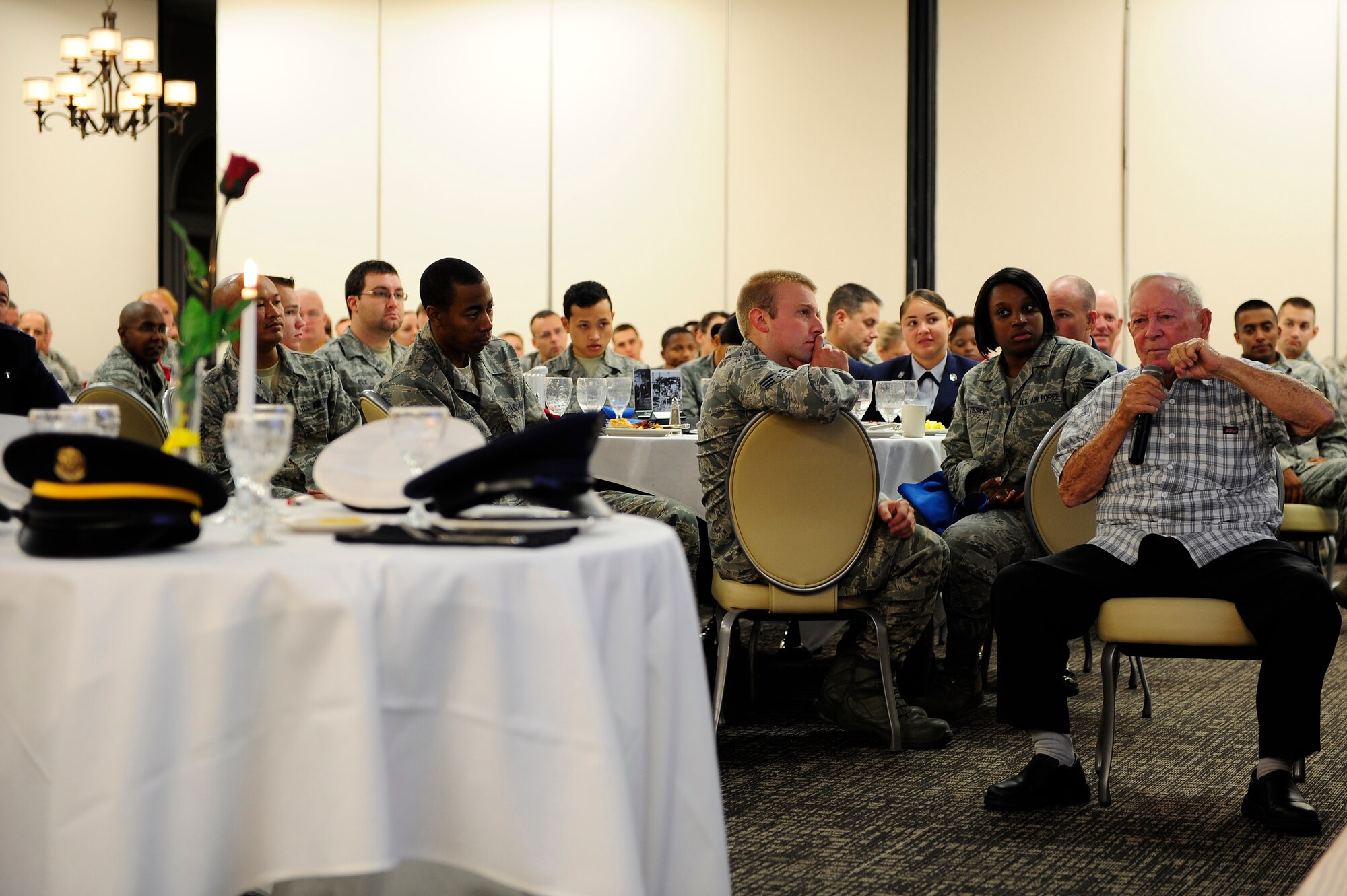 Guest speaker, and former prisoner of war retired Senior Master Sgt. Kenneth Duffy, sits and speaks at a POW/MIA breakfast, Shaw Air Force Base, S.C., Sept. 20, 2012. Duffy elaborated on the year he spent as a prisoner of war in prison camp Stalag 17-B in Krems, Austria. (U.S. Air Force photo by Airman 1st Class Daniel Blackwell/Released)