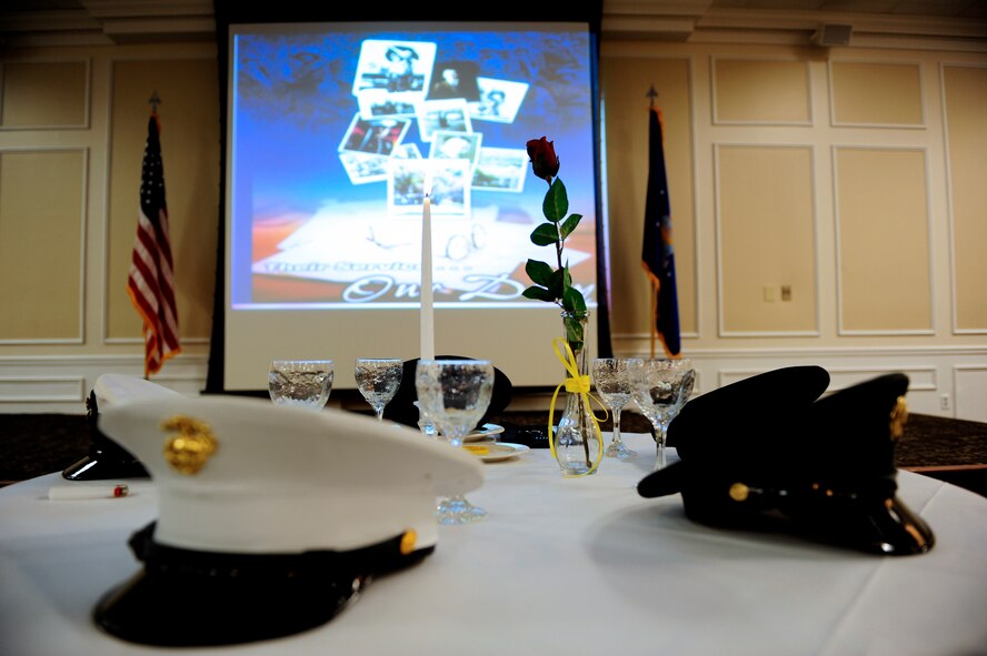 A prisoner of war and missing in action commemorative breakfast was held at Shaw Air Force Base, S.C., Sept. 20, 2012. The white tablecloth signifies the purity of their intentions to their country. The rose symbolizes those who gave their lives. The yellow ribbon stands for the unyielding demand for proper account of the missing. The lemon symbolizes the bitter fate of those not with us. The salt on the plate represents the tears of family and loved ones who keep the faith as they wait. The glasses on the table are inverted in remembrance of those who are with us in spirit. The table is set apart from the others for those who fought in defense of our country. The candle is lit to show vigilance for those still missing. (U.S. Air Force photo by Airman 1st Class Daniel Blackwell/Released)