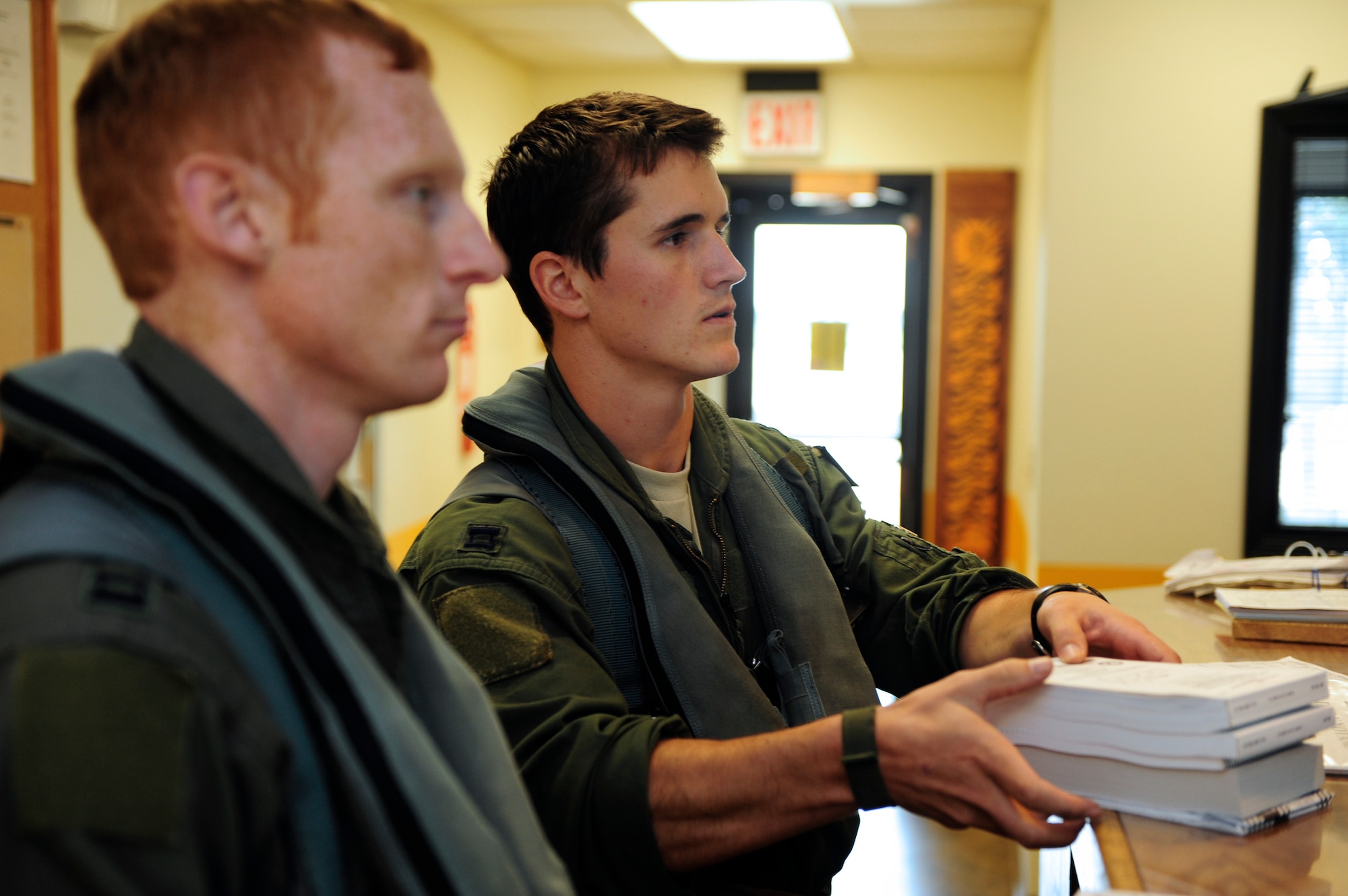 Capt. Eric Boyes (left), 79th Fighter Squadron chief of wing weapons and tactics, and F-16 pilot, and Capt. Jake Allen, 79th Fighter Squadron F-16 pilot listen as they are briefed before their training mission at Shaw Air Force Base, S.C., Sept. 21, 2012. Boyes is the Air Combat Command recipient of the Lance P. Sijan Leadership Award for 2012 for his innovative training programs and combat-oriented tactical planning in support of Operation New Dawn, as well as combat operations in Iraq. This award is given to officers and enlisted members who exhibit the highest levels of initiative and leadership in their duties. (U.S. Air Force photo by A1C Daniel Blackwell/Released)