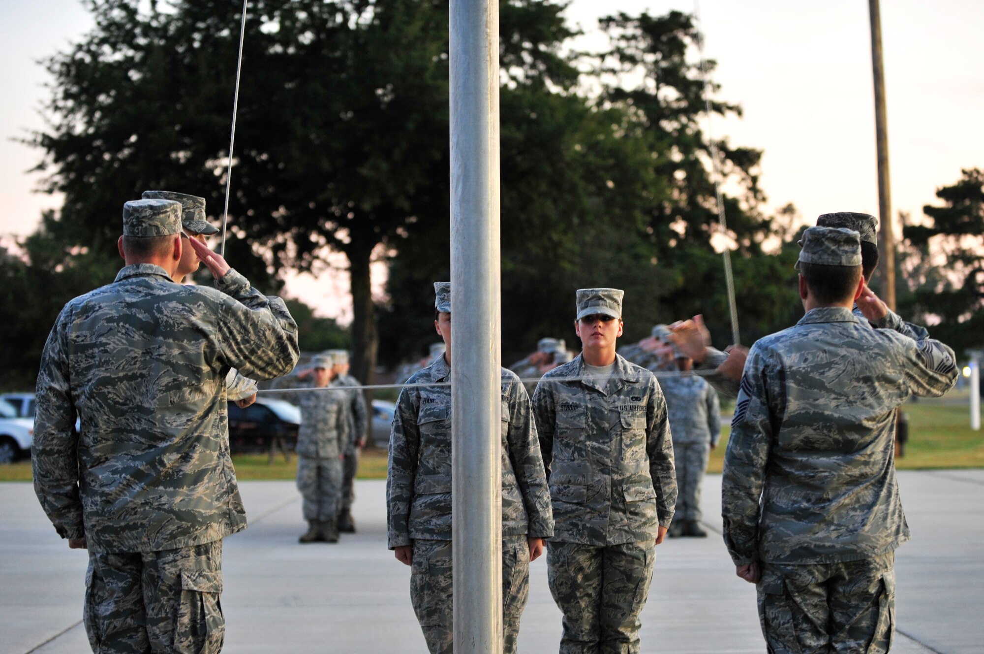 U.S. Air Force Airmen raise the flag during reveille, at the closing ceremony for the prisoner of war and missing in action recognition day, Shaw Air Force Base, S.C., Sept. 21, 2012.  Shaw Airmen ran for 24 hours to commemorate those lost at war. (U.S. Air Force photo by Airman Nicole Sikorski/Released)