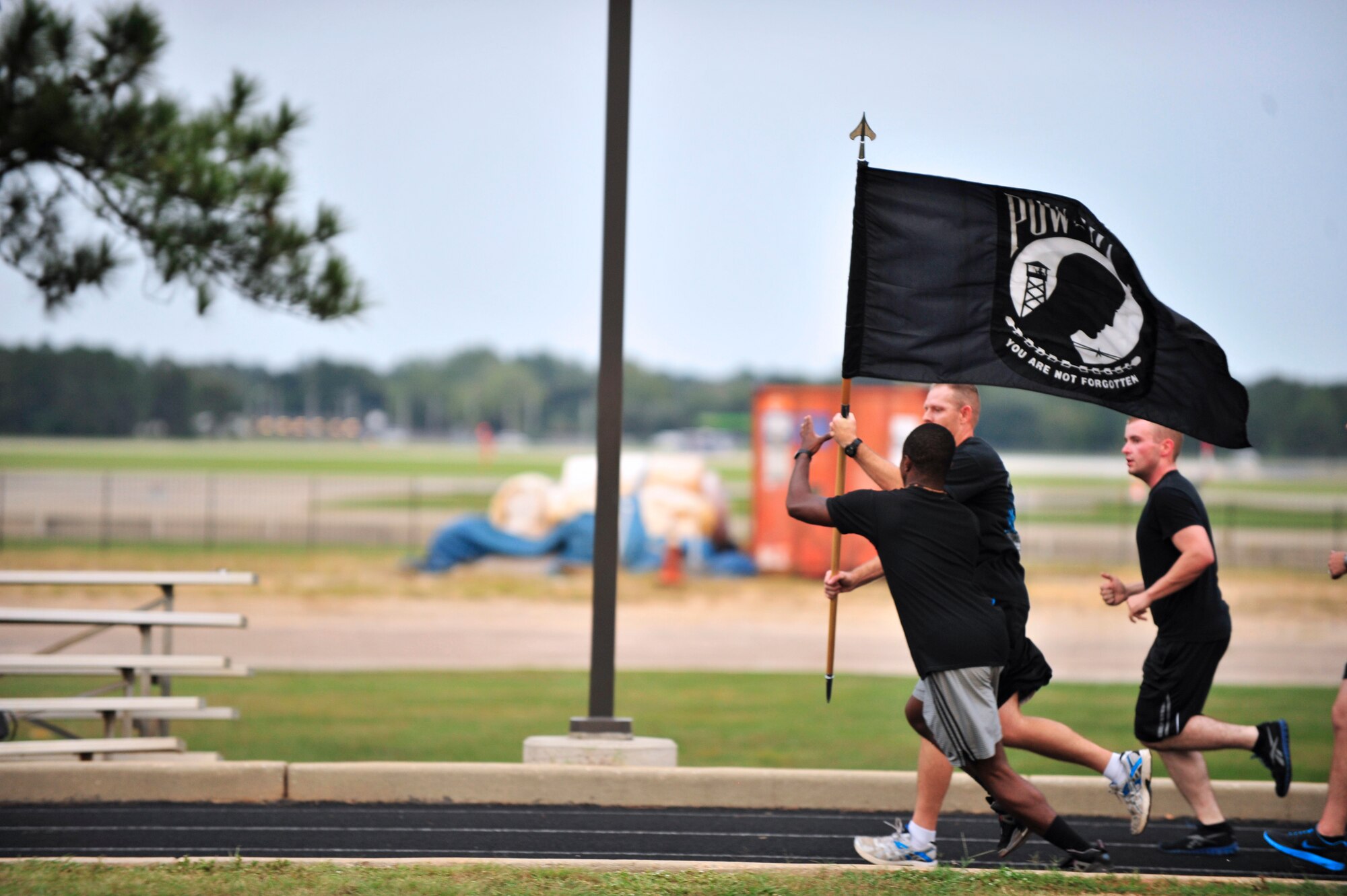U.S. Air Force Airmen from the 20th Force Support Squadron run for the prisoner of war and missing in action recognition day at Shaw Air Force Base, S.C., Sept. 20, 2012.  On the third Friday of September, the POW/MIA flag is flown to honor those lost at war.  The vigil signifies the perseverance of the United States in the search for POWs and MIA. (U.S. Air Force photo by Airman Nicole Sikorski/Released)