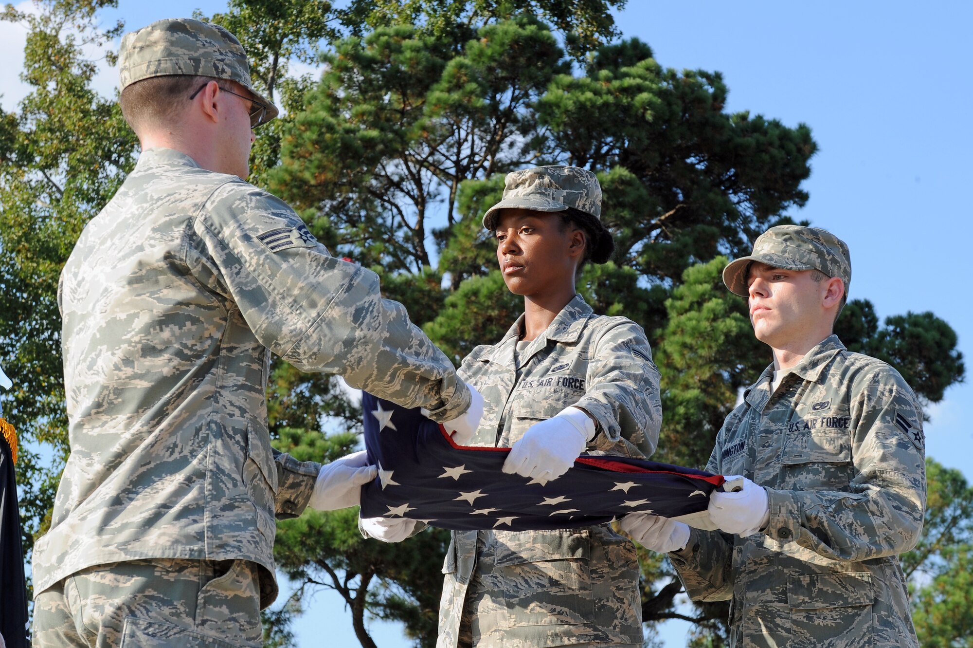 Members of the 4th Fighter Wing Honor Guard conduct a flag folding routine during the POW/MIA Remembrance Ceremony on Seymour Johnson Air Force Base, N.C., Sept. 21, 2012. During the routine, the masters of ceremonies explained what each fold in the flag represented. (U.S. Air Force photo/Airman 1st Class John Nieves Camacho/Released)