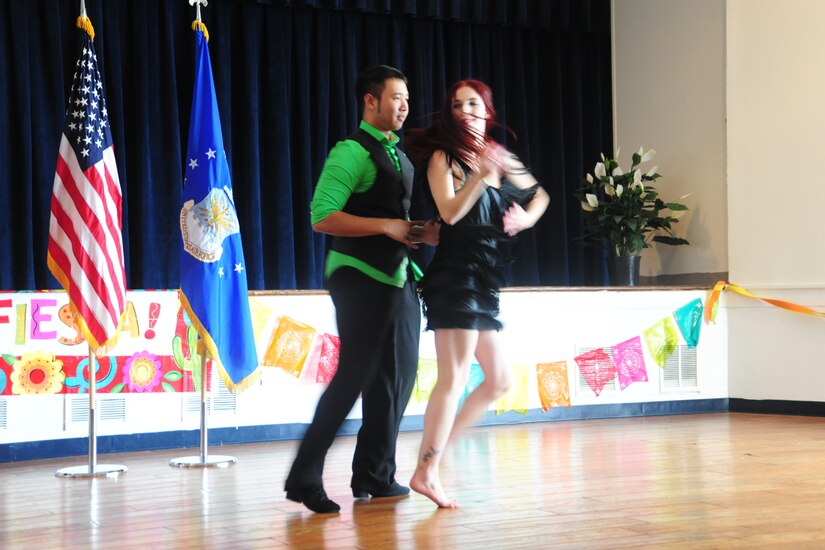 Myat Nyunt and Samantha Fries, of Arthur Murray Dance studio, demonstrate salsa, merengue, bachata and rumba dances during a Hispanic-American Heritage Month celebration  at the community activity center, Sept. 21, 2012. The event included a free ethnic-food tasting, a professional dancing demonstration, a live DJ and an opportunity for patrons to dance. (U.S. Air Force photo/ Senior Airman Amber Russell) 