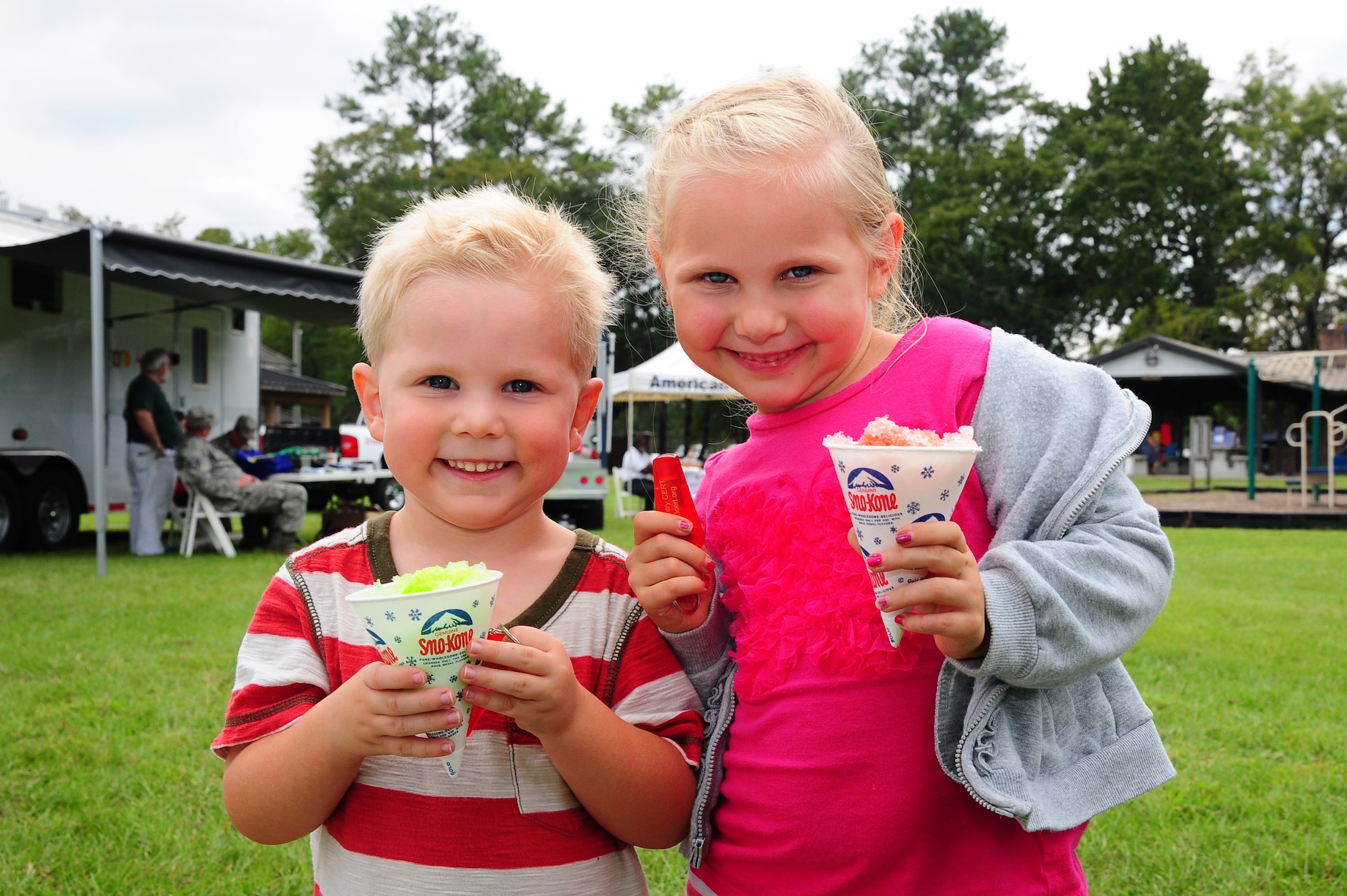 Claire Bernards and her brother Boston, enjoy snow cones during the National Emergency Preparedness night Sept. 20, 2012, at the Joint Base Charleston - Air Base picnic grounds. Claire and Boston's father is Capt. Paul Bernards, 16th Airlift Squadron pilot, 437th Airlift Wing. September marks the ninth annual National Emergency Preparedness Month sponsored by the Federal Emergency Management Agency in the U.S. Department of Homeland Security. The program encourages national, regional, local, public and private organizations to review and communicate emergency preparedness efforts. (U.S. Air Force photo/ Airman 1st Class Chacarra Walker)