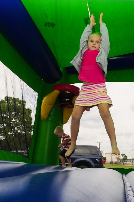 Claire Bernards, daughter of Capt. Paul Bernards, 16th Airlift Squadron pilot, 437th Airlift Wing, jumps in an inflatable bouncy house during the National Emergency Preparedness night Sept. 20, 2012, at the Joint Base Charleston - Air Base picnic grounds. September marks the ninth annual National Emergency Preparedness Month sponsored by the Federal Emergency Management Agency and the U.S. Department of Homeland Security. The program encourages national, regional, local, public and private organizations to review and communicate emergency preparedness efforts.  (U.S. Air Force photo/ Airman 1st Class Chacarra Walker)