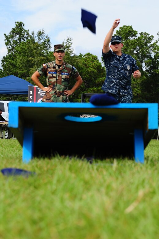 Master-at-Arms Petty Officer 2nd Class Michael Jones, 628th Security Forces Squadron, and Civil Air Patrol volunteer Samuel Bolin, play corn hole Sept. 20, 2012, during the National Emergency Preparedness night at the Joint Base Charleston - Air Base picnic grounds. September marks the ninth annual National Emergency Preparedness Month sponsored by the Federal Emergency Management Agency and the U.S. Department of Homeland Security. The program encourages national, regional, local, public and private organizations to review and communicate emergency preparedness efforts. (U.S. Air Force photo/ Airman 1st Class Chacarra Walker)