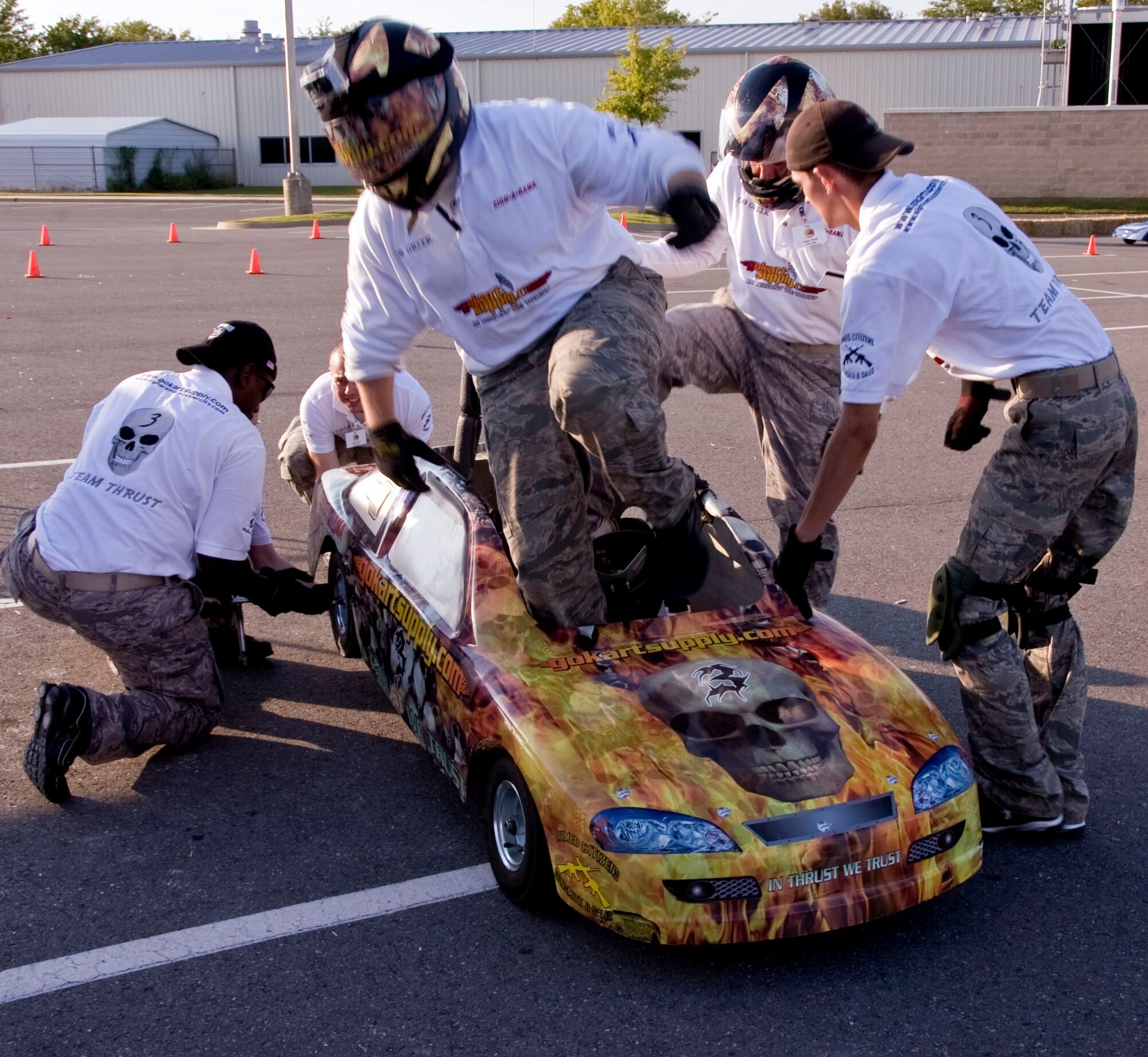 Staff Sgt. William Heinemann, 2nd Security Forces Squadron, jumps out of a go-kart to make a driver change during the fourth annual Bossier Parish Community College 100 Mini 'NASCARR' Race Sept. 22. During the driver change, the pit-crew is required to change one tire as fast as possible.  The 2 SFS six-man team participated in the event to help raise money to support students attending BPCC. (U.S. Air Force photo/Staff Sgt. La'Shanette V. Garrett)(RELEASED)