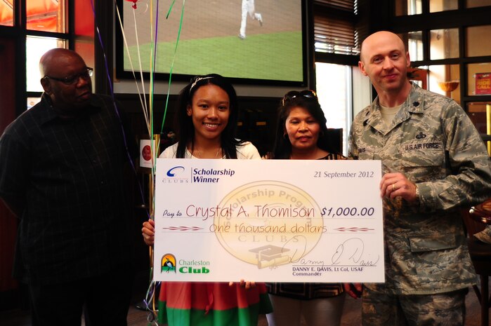 Lt. Col. Danny Davis, 628th Force Support Squadron commander, presents Crystal Thomison (second from left) a $1,000 check from the Air Force Services Club Membership Scholarship Program Sept. 21, 2012 at Joint Base Charleston – Air Base, S.C. The club assists club members and their families with the cost of higher education. Twenty-five winners were selected from the 109 entries this year and each winner received a $ 1,000 award. Also pictured are Crystal's parents, retired Tech. Sgt. William and Clair Thomison. (U.S. Air Force photo/ Airman 1st Class Chacarra Walker)