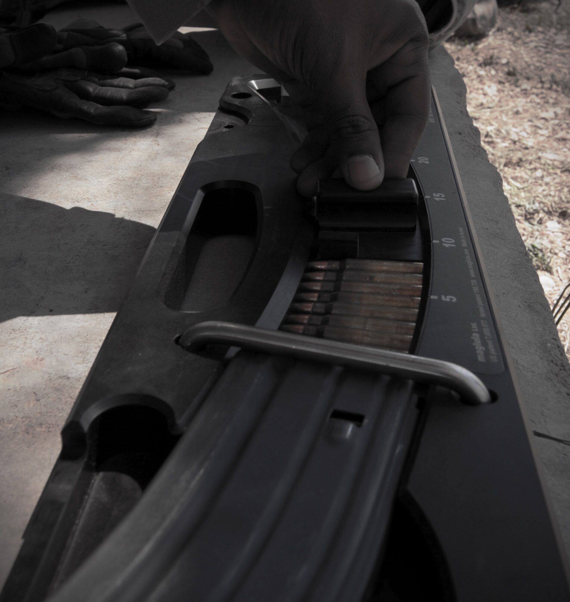 An Airman from the 7th Security Forces Squadron loads an M-4 magazine before training for the 3rd annual Global Strike Challenge Sept. 20, 2012, at the Modified Record Fire Range, in Brownwood, Texas.  During the competition Dyess security forces will compete in marksmanship on the M-4, M-9, M-240 and M-230 weapons systems, combat tactics and priority resource defense, and the mental and physical challenge event. (U.S. Air Force photo by Airman 1st Class Jonathan Stefanko/ Released)