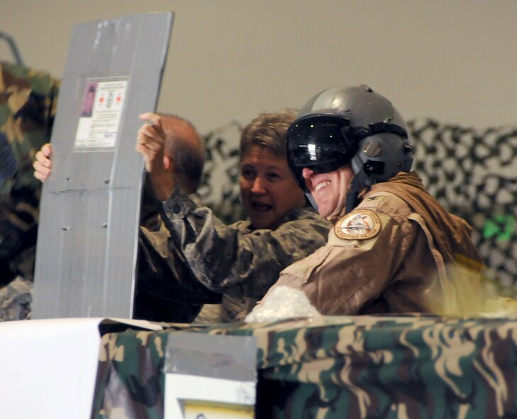 Chaplain Elaine Henderson and 178th Mission Support Squadron commander Col. Joseph Schulz prepare for impact from an approaching water balloon at the 178th Fighter Wing Combat Dining In Sept. 22. The event was held at the Springfield Air National Guard Base, Springfield Ohio. (U.S. Air Force photo by Senior Master Sgt. Joseph R. Stahl/Released)