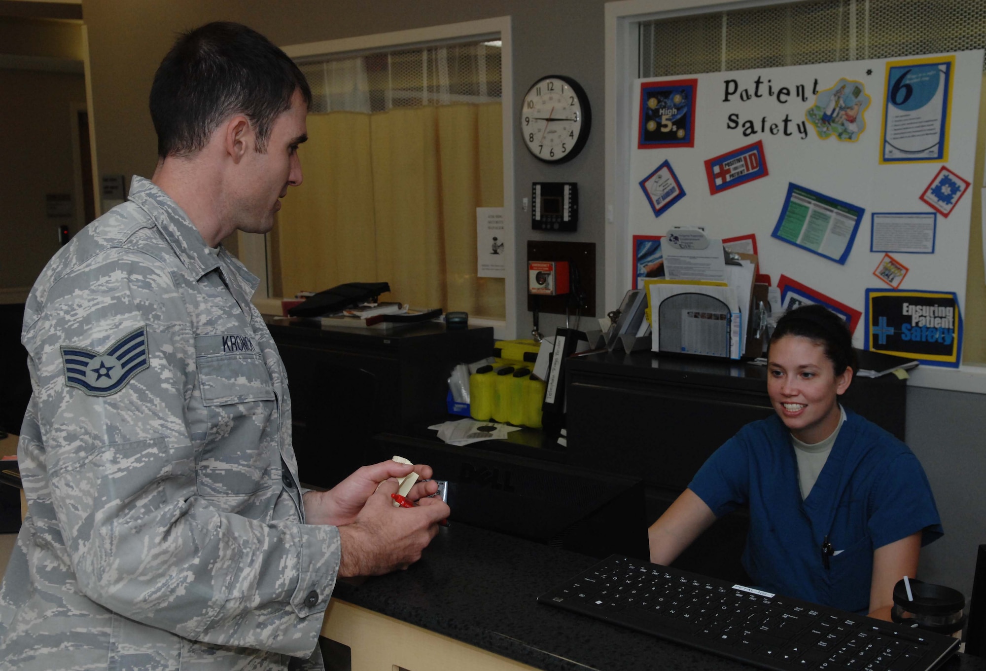 2nd Lt. Melissa Poole, 633rd Medical Group clinical nurse, and first in the Air Force Marathon overall military female category, discusses patient care with a fellow Airman, Sept. 25, 2012, at Langley Air Force Base. When Poole isn’t working at the U.S. Air Force Hospital Langley maternity ward, she is out training for marathons. (U.S. Air Force photo by Airman 1st Class Austin Harvill/Released)
