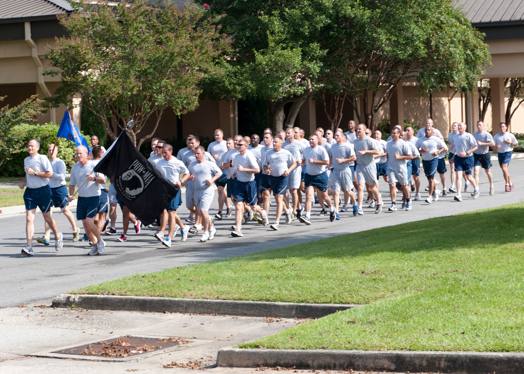 Moody Airmen finish the last few feet of the 4th annual Tiger-thon run toward  the Moody Prisoner of War/Missing in Action Memorial Park where the remembrance run ended Sept. 21, 2012, at Moody Air Force Base, Ga. Twenty three units on the base ran the 23-mile relay run, tapping each other out at each mile, with some continuing further in remembrance of the men and women who have yet to come home from war. (U.S. Air Force photo by Senior Airman Eileen Meier/Released)