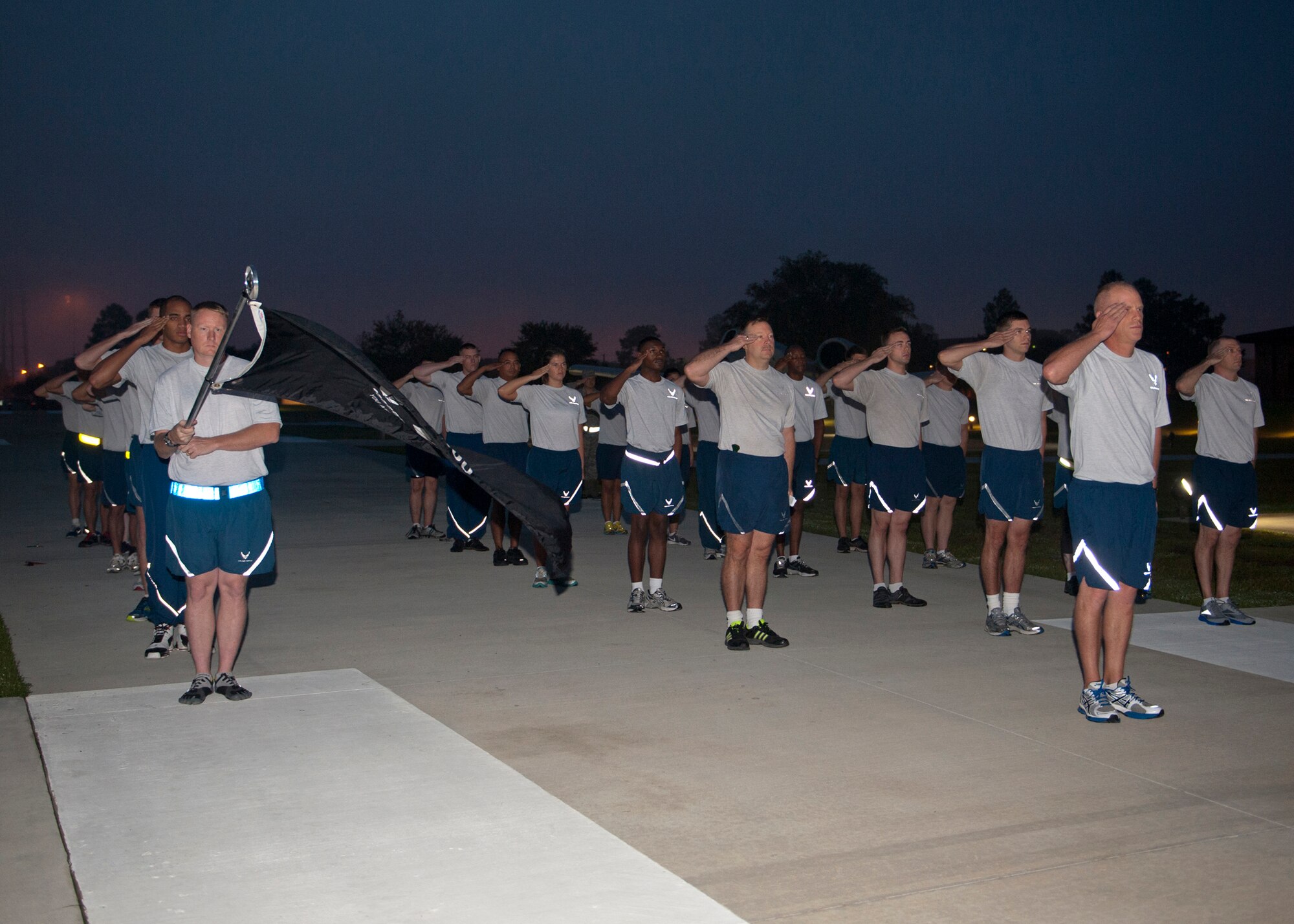 Airmen with the 23d Wing salute during the playing of reveille for the 4th annual Tiger-thon run for Prisoner of War/Missing in Action Recognition Day at the President George W. Bush Air Park at Moody Field Sept. 21, 2012, at Moody Air Force Base, Ga. The 23-mile relay run began on base, went down Bemiss Road  in Valdosta and ended at the Moody POW/MIA Memorial Park. (U.S. Air Force photo by Senior Airman Eileen Meier/Released)