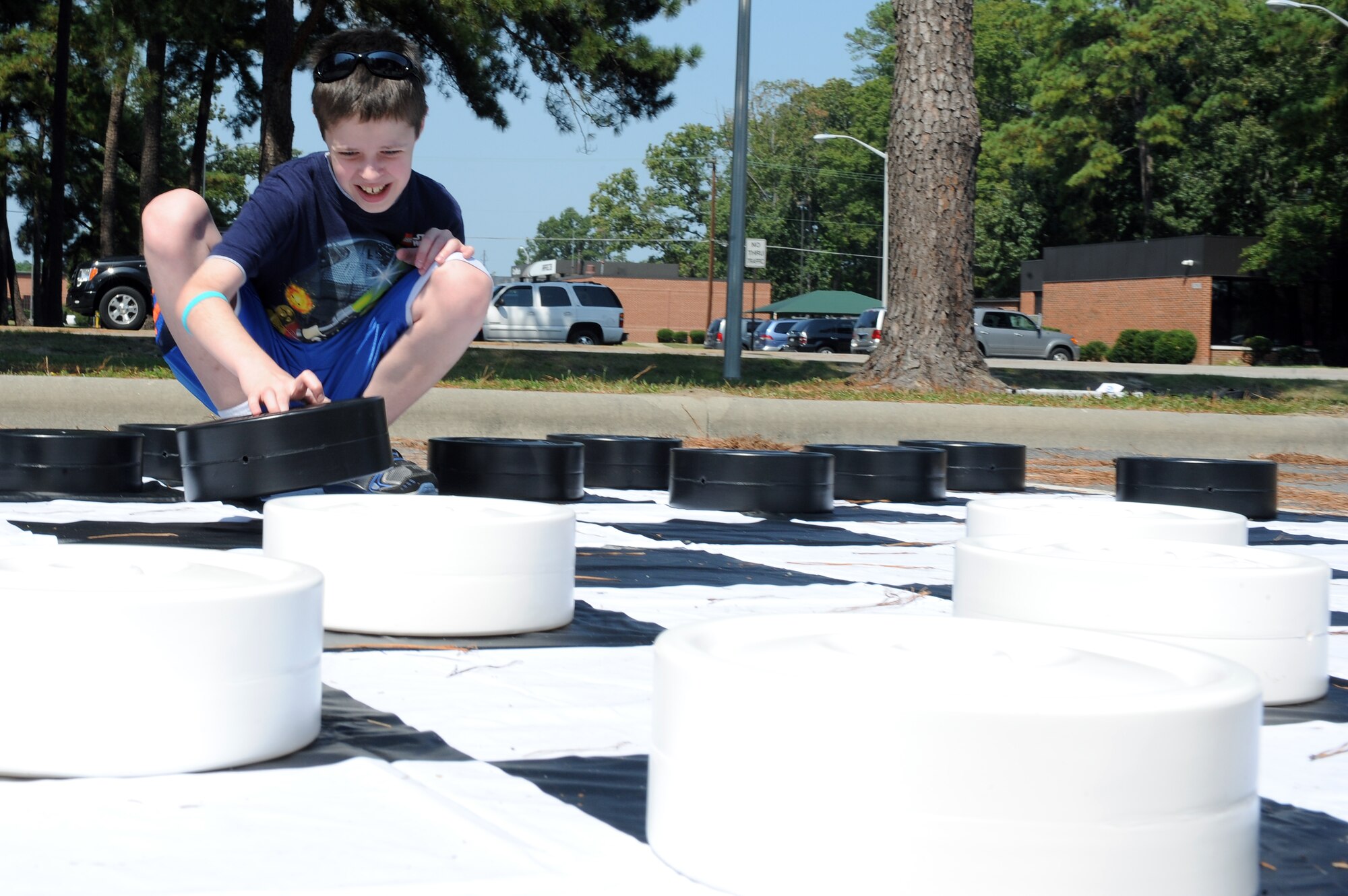 Tyler Rash, 12, plays checkers during the Worldwide Day of Play on Seymour Johnson Air Force Base, N.C., Sept. 22, 2012. Checkers was one of the many activities children could participate in during the event. Tyler is the son of Tech. Sgt. William Rash, 4th Maintenance Operations Squadron engine manager. (U.S. Air Force photo/Airman 1st Class John Nieves Camacho/Released)