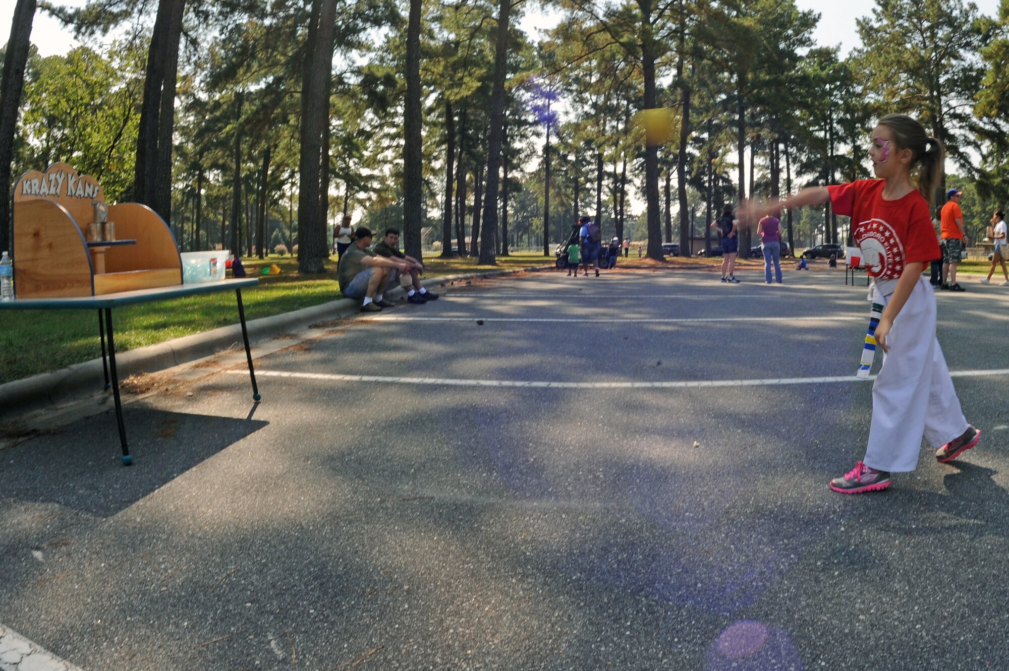 Blair Sarvis, 7, participates in the “Krazy Kans” game during the Worldwide Day of Play on Seymour Johnson Air Force Base, N.C., Sept. 22, 2012. The objective was to knock down three cans with a ball to win a wristband. (U.S. Air Force photo/Airman 1st Class John Nieves Camacho/Released)