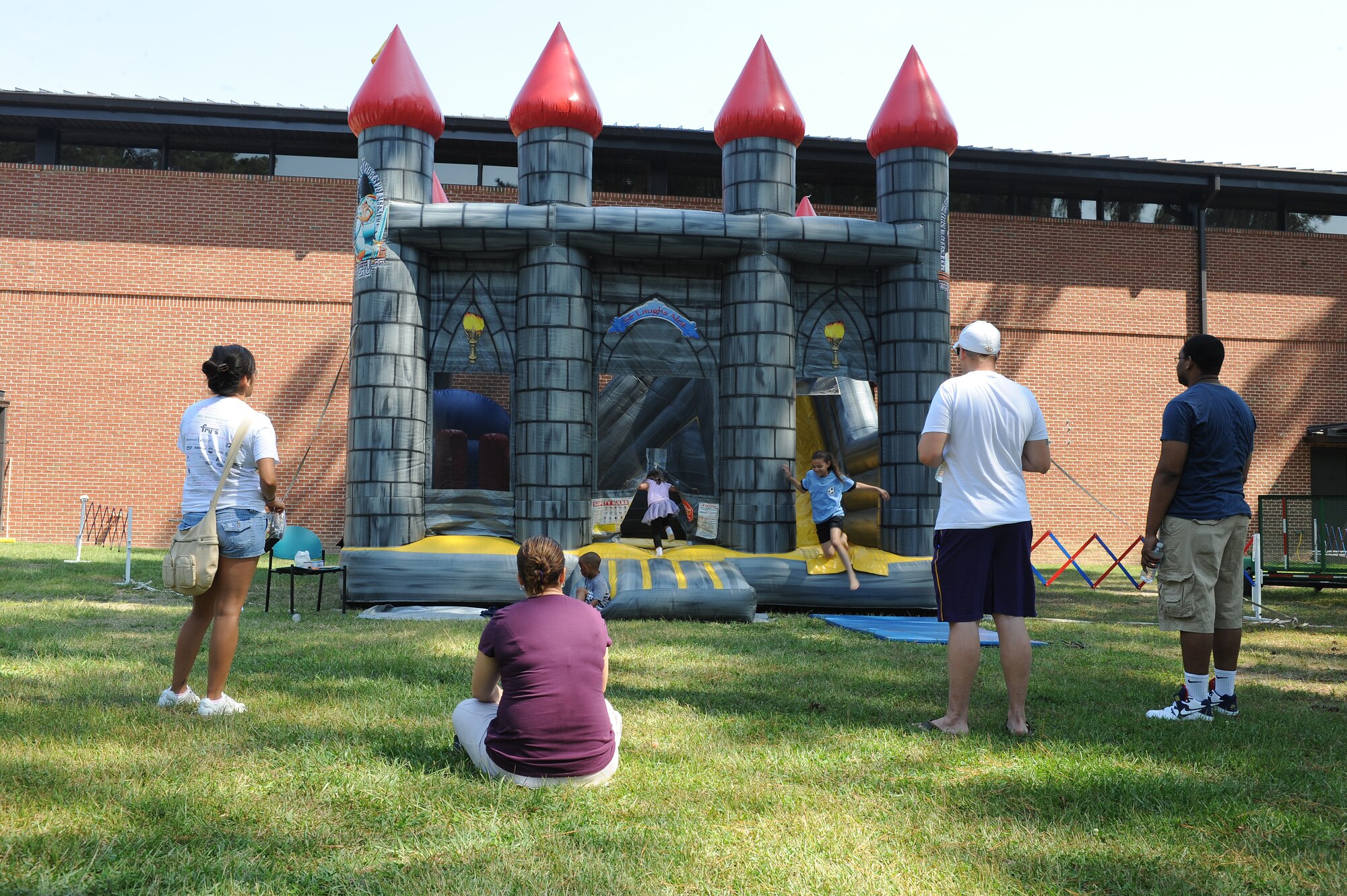 Parents watch as their children play in a bouncey house during the Worldwide Day of Play on Seymour Johnson Air Force Base, N.C., Sept. 22, 2012. The Worldwide Day of Play encouraged children to get out and be active, instead of staying indoors. (U.S. Air Force photo/Airman 1st Class John Nieves Camacho/Released)