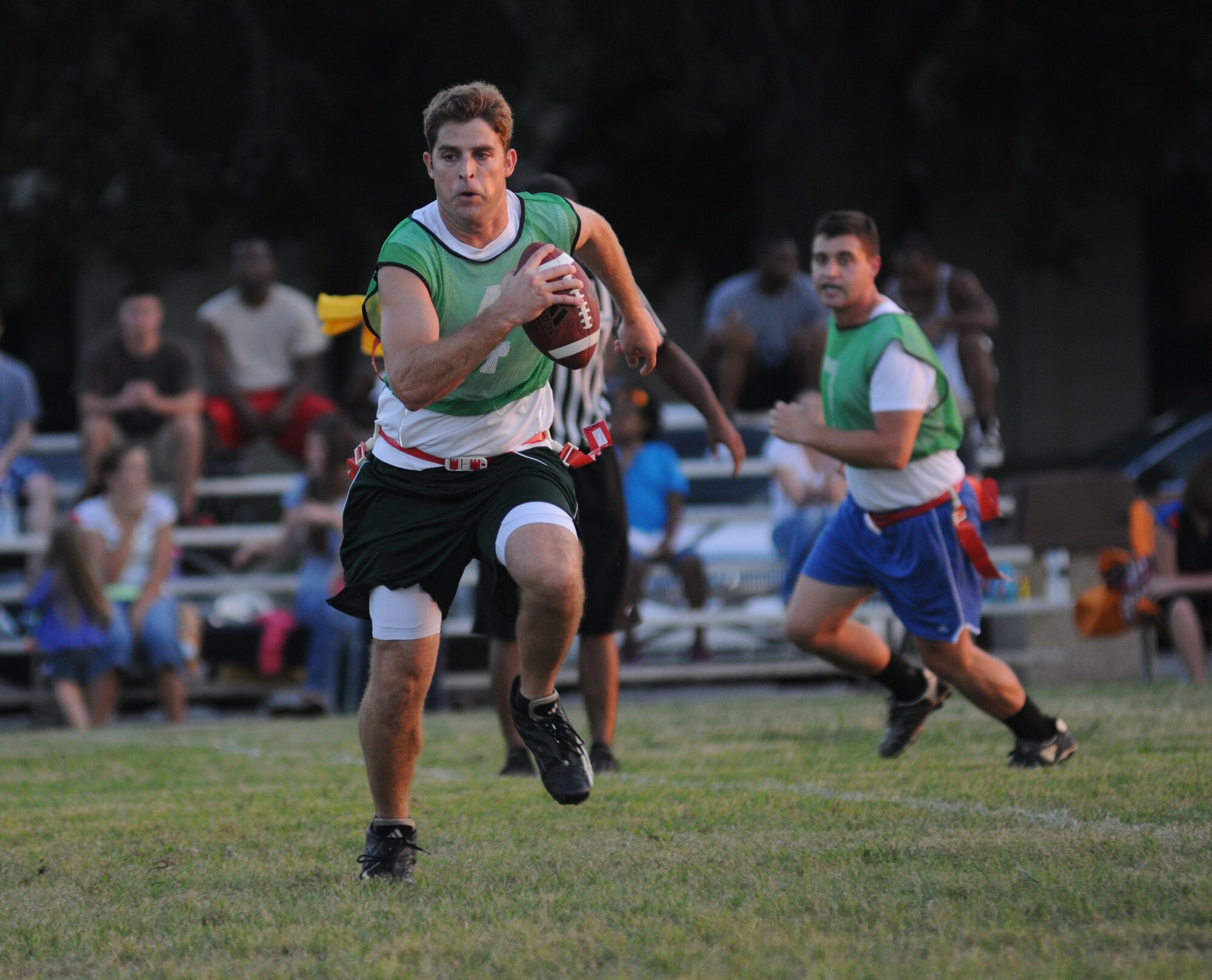 Matt Sarb, 81st Surgical Operations Squadron runs the ball looking to make a pass while his teammate, Gary McGiffin, looks for an opening in the defense during an intramural flag football game against Keesler Marine Detachment Sept. 19, 2012, at Keesler Air Force Base, Miss. MARDET defeated the 81st MSGS, 13-0.  (U.S. Air Force photo by Kemberly Groue)