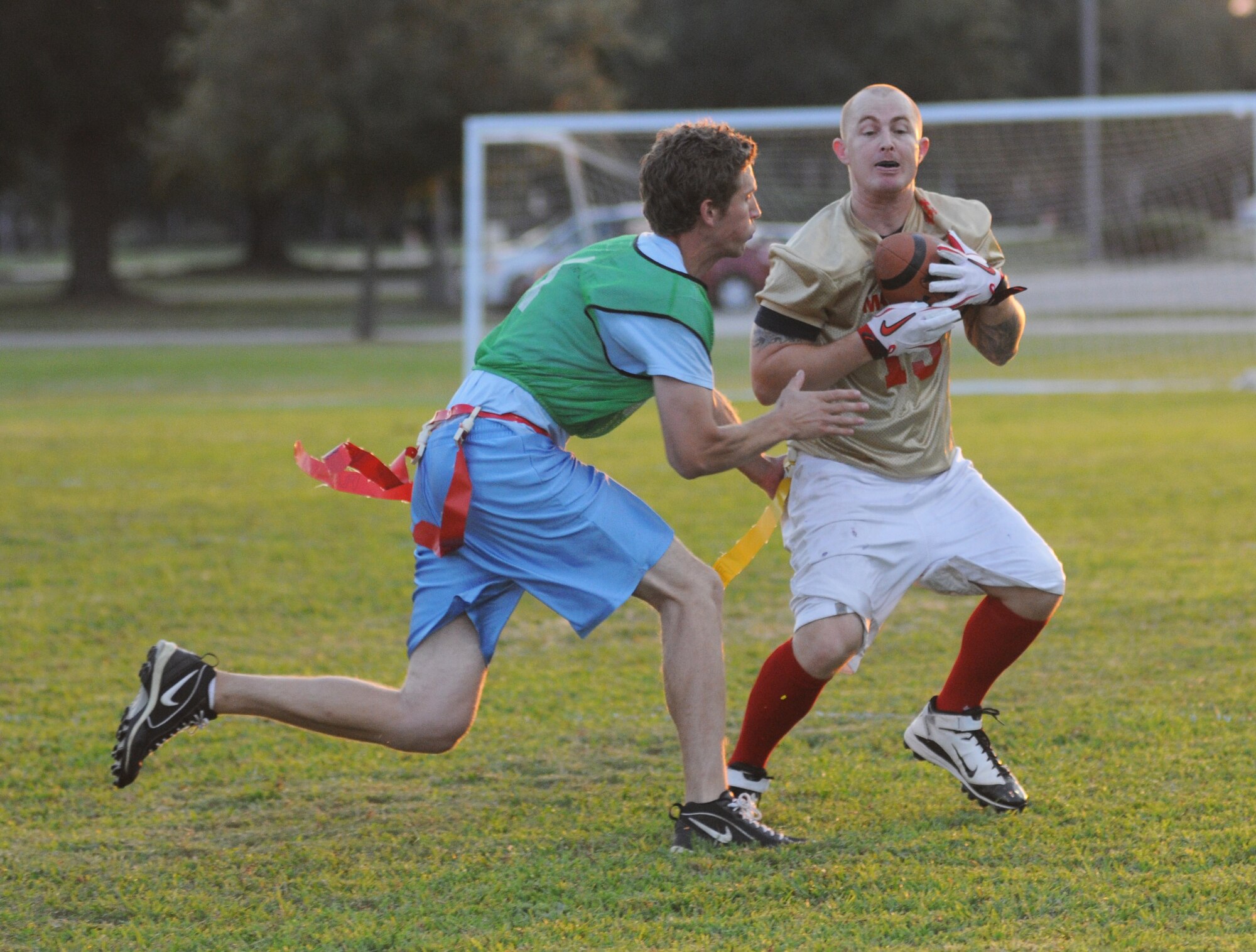 Matt Mitchell,  81st Surgical Operations Squadron, grabs the flag of Carlos Macias, Keesler Marine Detachment, as he makes a run towards the end zone during an intramural flag football game Sept. 19, 2012, at Keesler Air Force Base, Miss.  MARDET defeated the 81st MSGS, 13-0.  (U.S. Air Force photo by Kemberly Groue)