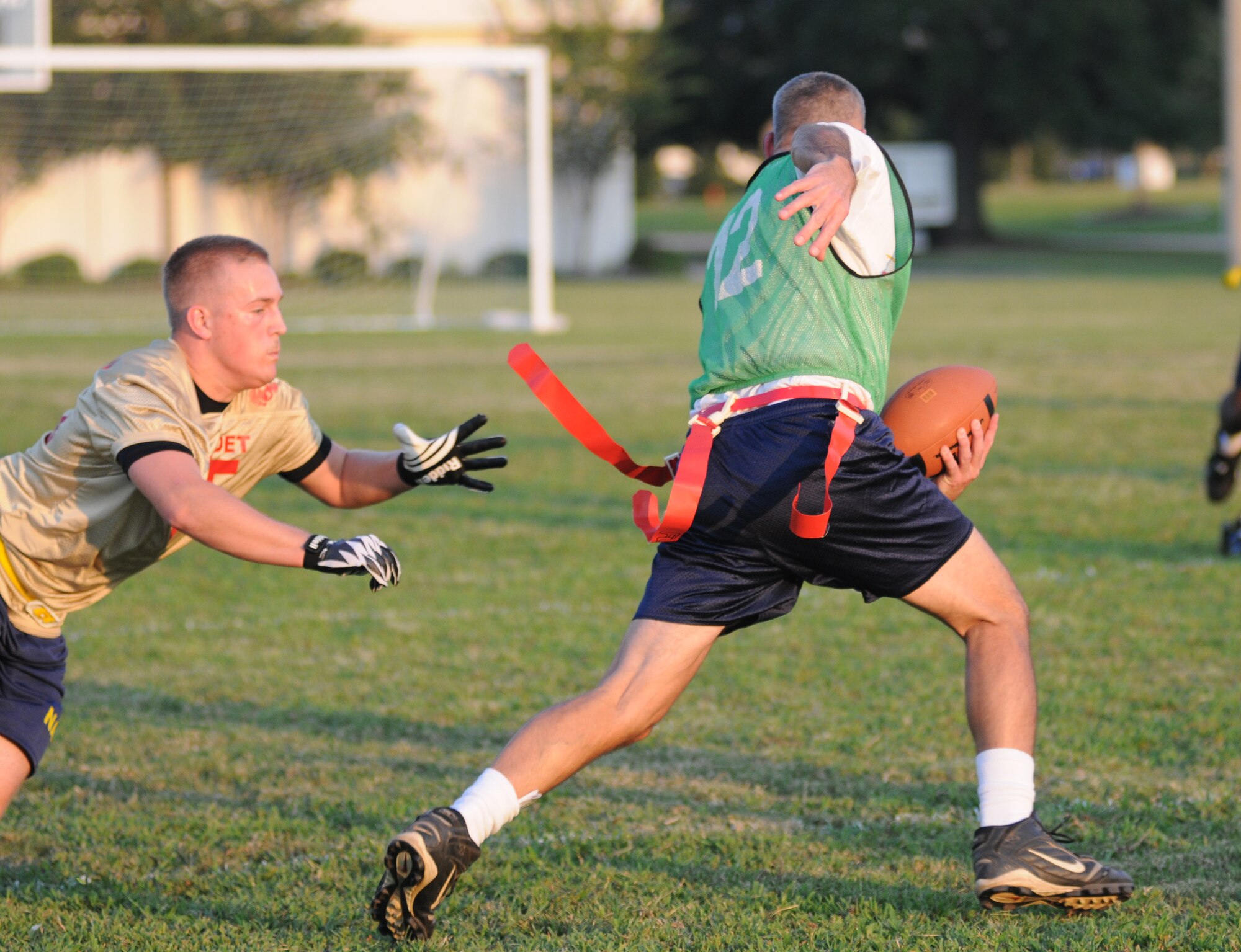 Dustin Vaughan, Keesler Marine Detachment, stretches out to grab the flag of Brian Katen, 81st Surgical Operations Squadron, as Katen attempts to run around Vaughan during an intramural flag football game Sept. 19, 2012, at Keesler Air Force Base, Miss.  MARDET defeated the 81st MSGS, 13-0.  (U.S. Air Force photo by Kemberly Groue)
