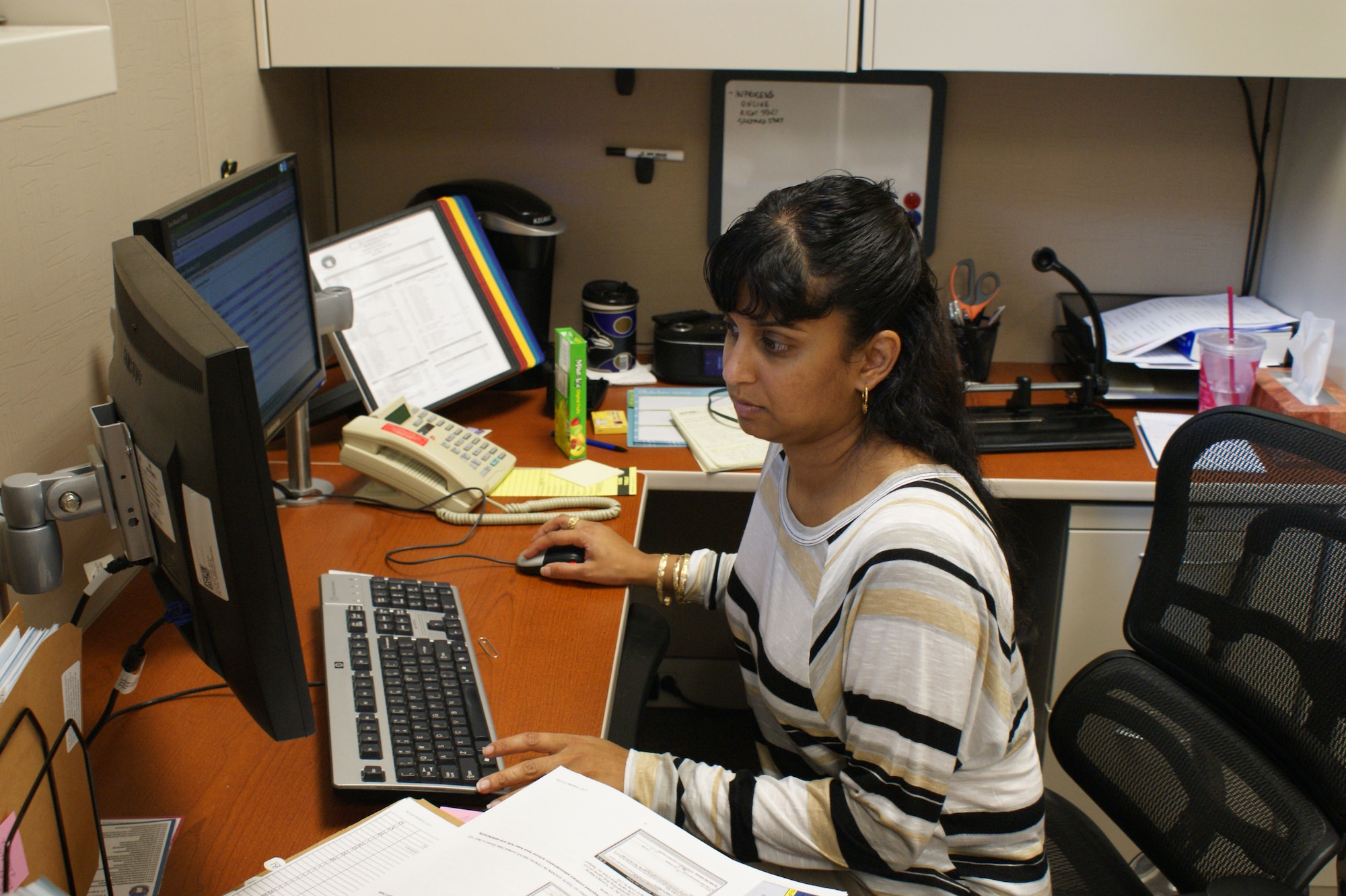 Vashti Hawkins, 82nd Contracting Squadron, reviews a purchase order Sept. 20, 2012, during end-of-year "soft" closeout operations at Sheppard Air Force Base, Texas.  The 82nd CONS and 82nd Comptroller Squadron work side-by-side ensuring the base's annual budget is executed on time.  (U.S. Air Force photo/Dan Hawkins)
