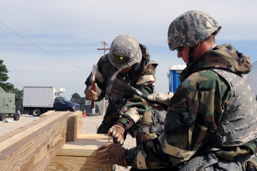 U.S. Air Force Airman Demetri Tsika (right) 4th Civil Engineer Squadron structural apprentice, and Senior Airman Jonathan Garcia, 4th CES structural journeyman, construct a drop arm during Phase II of Operational Readiness Exercise Coronet Warrior 12-04 at a simulated deployed location on Seymour Johnson Air Force Base, N.C., Sept. 20, 2012. Simulated wartime contingency exercises like CW 12-04 test an Airman’s ability to defend and execute the 4th Fighter Wing’s mission of providing precision combat airpower anytime, anywhere in a heightened state of readiness. (U.S. Air Force photo/Airman 1st Class John Nieves Camacho/Released)