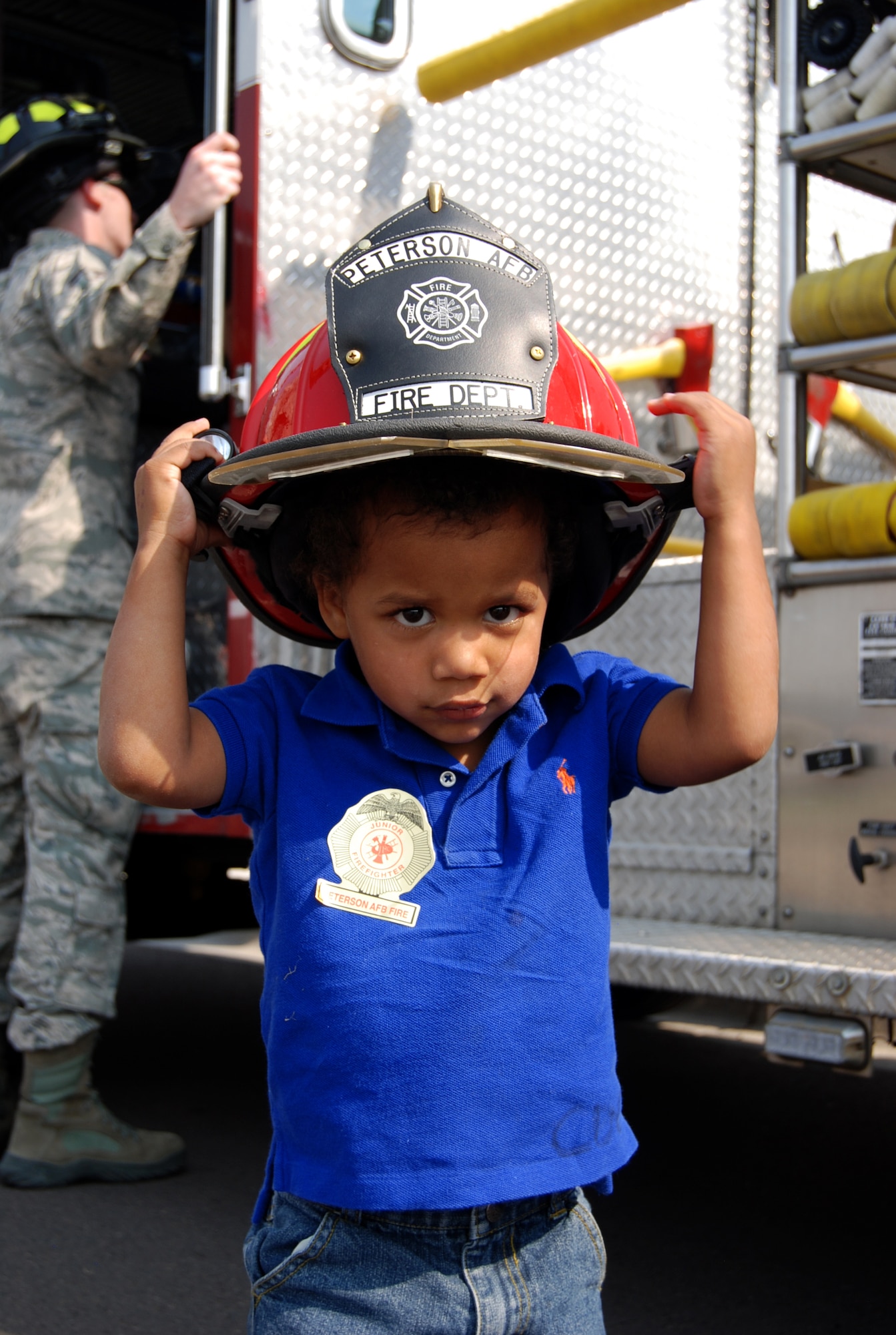 La Ron Wilkins, son of Senior Airman Ronell Wilkins, 76th Space Control Squadron, tries out a fireman’s helmet during the annual Snow Parade Sept. 19, 2012, at the main Child Development Center. The kids got to see a variety of fire trucks, snow plows and dump trucks up close during the parade. The purpose of the Snow Parade is not only to educate children and the base populace, but also to ensure that all the equipment is in proper working order before the winter season. (U.S. Air Force photo/Lea Johnson)