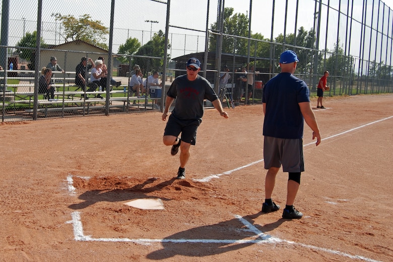 Col. Chris Crawford, 21st Space Wing commander, scores a run for the Eagles during the Chiefs versus Eagles softball game Sept. 20, 2012. The Chiefs went on to beat the Eagles 13-5. (U.S. Air Force photo/Lea Johnson)