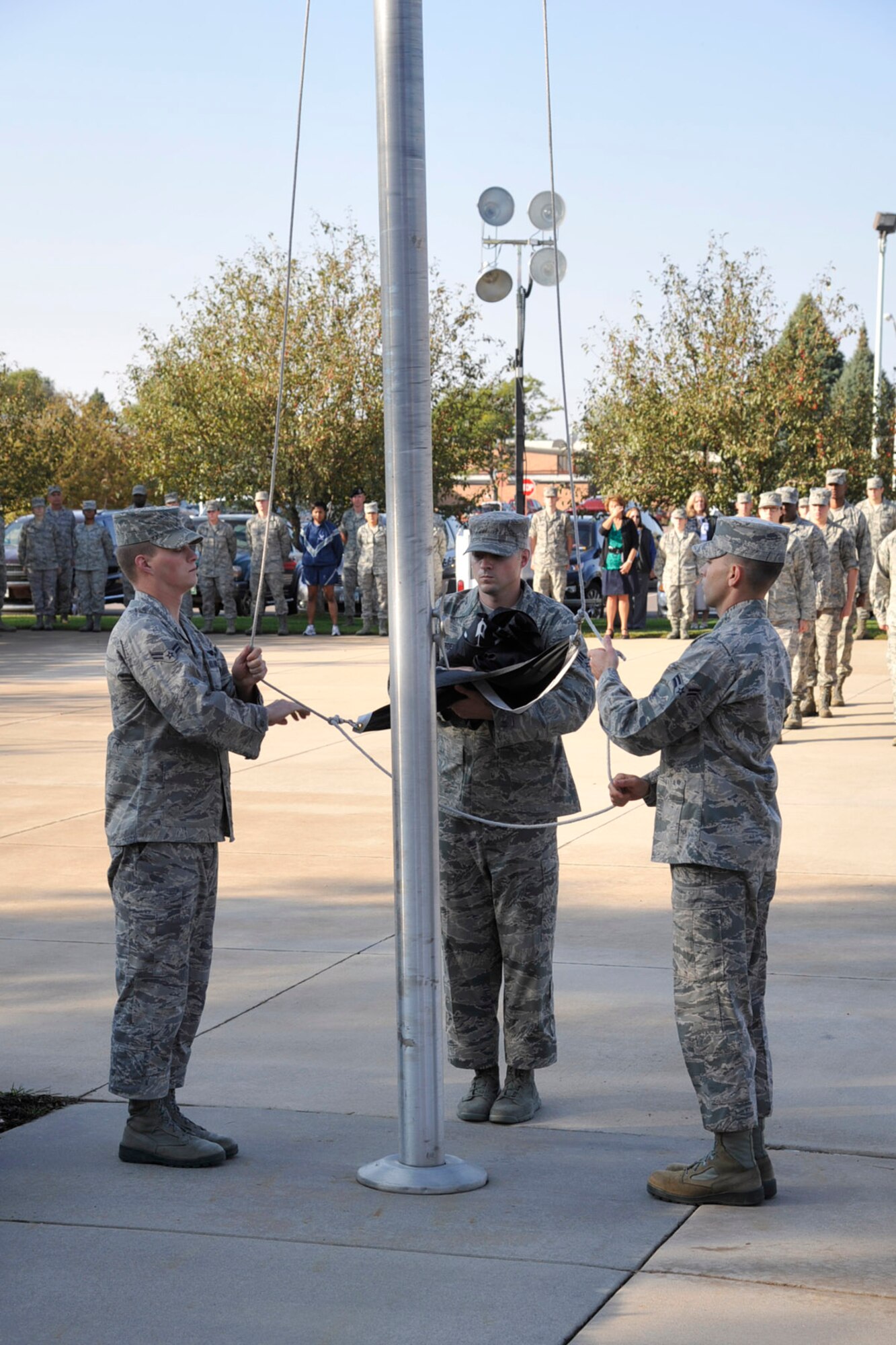 Airmen from the High Frontier Honor Guard ceremoniously lower the POW/MIA flag Sept. 20 at the Vosler NCO Academy. The ceremony was part of Peterson AFB POW/MIA week activities. (U.S. Air Force photo/Robb Lingley)