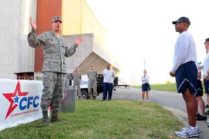 U.S. Air Force Col. Korvin Auch, 633rd Air Base Wing commander, delivers a speech before the start of the Combined Federal Campaign 5K run at Langley Air Force Base, Va., Sept. 25, 2012. Civilian and military donors support eligible non-profit organizations that provide health and human service benefits throughout the world. (U.S. Air Force photo by Staff Sgt. Ashley Hawkins/Released)