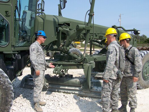 Tech. Sgt. David Carr with a group of students doing a walk around safety inspection of a Caterpillar 120M. (Courtesy Photo)