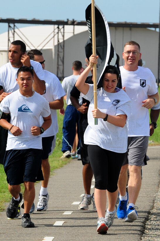 From left, U.S. Air Force Airman 1st Class Jeronebeth Medico, Tech. Sgt. Jacqueline Milian and Master Sgt. Charles VanPelt honor the nation’s prisoners of war, and those missing in action, by participating in the POW-MIA Remembrance Vigil run at Langley Air Force Base, Va., Sept. 20, 2012. The National POW-MIA Recognition Day is observed across the United States on the third Friday of September, every year.  (U.S. Air Force photo by Airman 1st Class Kayla Newman/Released)