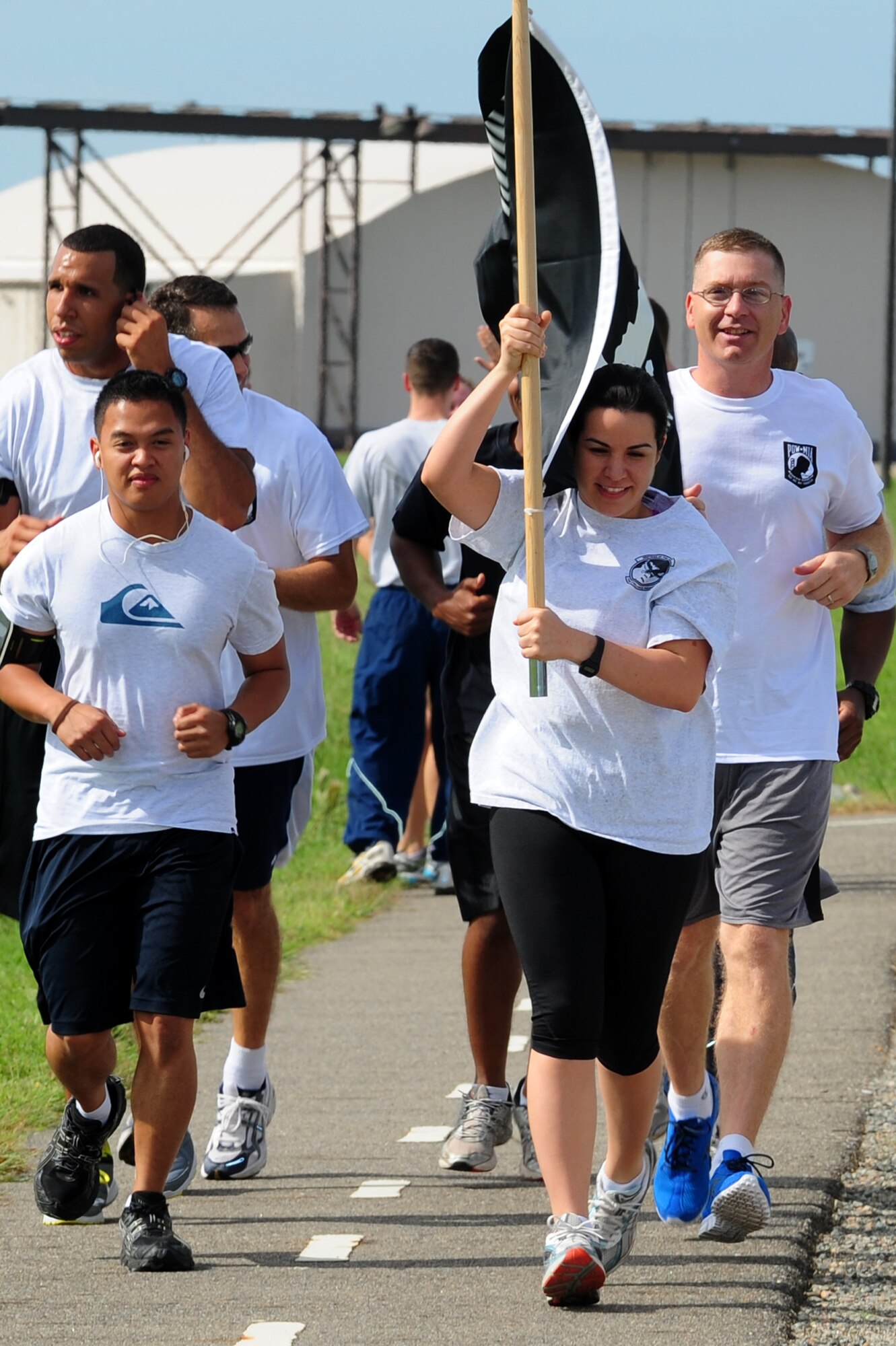 From left, U.S. Air Force Airman 1st Class Jeronebeth Medico, Tech. Sgt. Jacqueline Milian and Master Sgt. Charles VanPelt honor the nation’s prisoners of war, and those missing in action, by participating in the POW-MIA Remembrance Vigil run at Langley Air Force Base, Va., Sept. 20, 2012. The National POW-MIA Recognition Day is observed across the United States on the third Friday of September, every year.  (U.S. Air Force photo by Airman 1st Class Kayla Newman/Released)