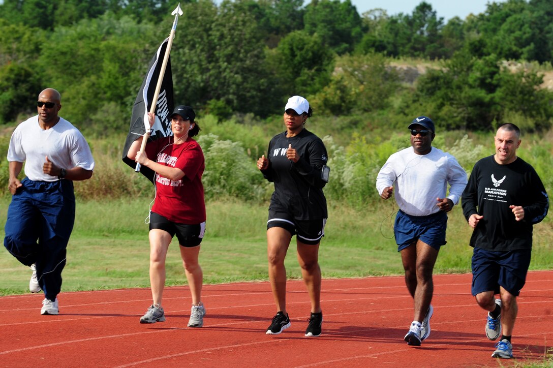 U.S. Air Force chief master sgts. kick off the third annual POW-MIA Remembrance Vigil run at Langley Air Force Base, Va., Sept. 20, 2012.  Langley Airmen carried the POW-MIA flag non-stop, in honor of American personnel listed as missing and unaccounted for. (U.S. Air Force photo by Airman 1st Class Kayla Newman/Released)