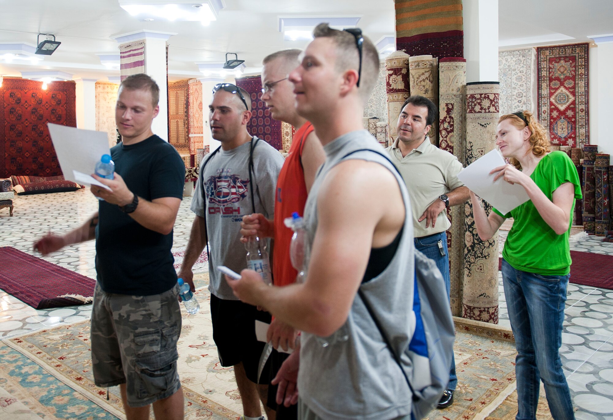 Two teams guess carpet designs as part of a challenge during Incirlik's Amazing Race Sept. 22, 2012, at Incirlik Village, Turkey. Eight teams traveled across the base and into parts of Adana accomplishing various challenges while competing for first place. The event kicked off Incirlik's Combined Federal Campaign with all team fees going to charity. (U.S. Air Force photo by Senior Airman Clayton Lenhardt/Released)
