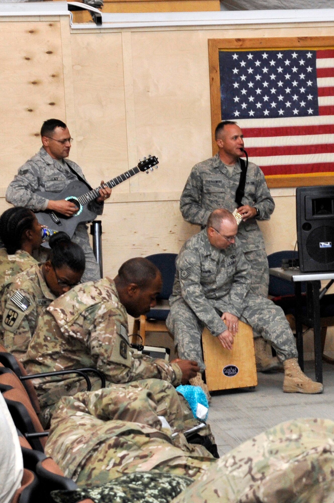 Left to right, Staff Sgt. Gregory Lacy, Tech. Sgt. Chad Newman and Master Sgt. Darrin Dziergowski, members of the U.S. Air Forces Central Band "Top Flight" entertain Soldiers, Airmen and civilians while they wait for their flight at the passenger terminal at the Transit Center at Manas, Sept. 22, 2012. Top Flight spent the day performing for service members who were on their way home from Afghanistan as a way to boost morale and bring them a little closer to home. The band is deployed from Joint Base San Antonio and is currently on a 12-day tour to the Transit Center. Lacy plays lead guitar and is a native of Houston, Newman is a percussionist from Arlington, Texas and Dziergowski is a keyboardist and a native of Suitland, Md. (U.S. Air Force photo/Master Sgt. Jason Vaught)

