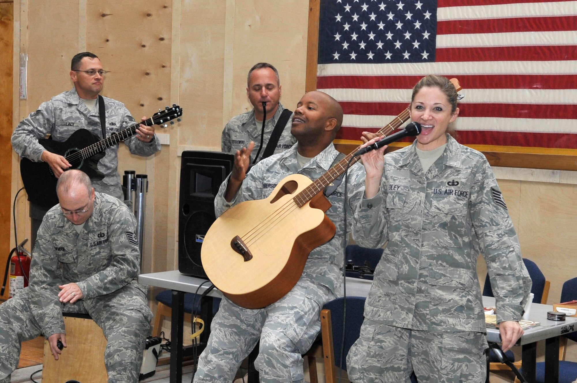 Members of the U.S. Air Forces Central Band "Top Flight" entertain Soldiers, Airmen and civilians while they wait for their flight at the passenger terminal at the Transit Center at Manas, Sept. 22, 2012. The deployed men and women were in transit on their way home when the band stopped in to share a few songs. Top Flight spent the day performing for service members who were on their way home from Afghanistan as a way to boost morale and bring them a little closer to home. Top Flight, a six-person band from Joint Base San Antonio, Texas, is on a 12-day tour to perform for military members throughout the Transit Center and the Kyrgyz Republic. (U.S. Air Force photo/Master Sgt. Jason Vaught)