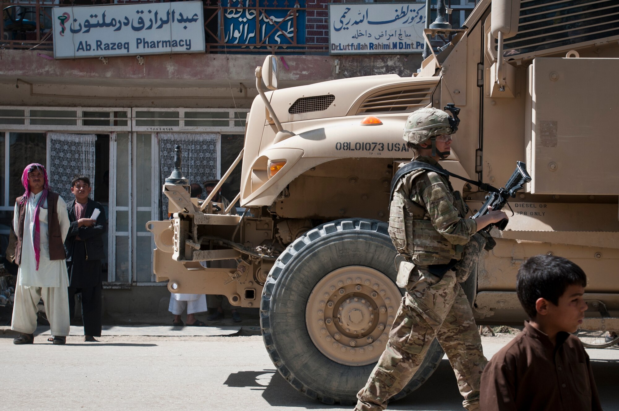 An Airman with the 455th Expeditionary Security Forces Squadron directs vehicles after a successful equipment delivery and meeting with the Afghan National Police at the ANP Bagram district headquarters outside Bagram Airfield, Afghanistan, Sept. 22, 2012. 455 ESFS is responsible for maintaining security on and around BAF to ensure safe operations. (U.S. Air Force photo/SMSgt Dale Canofari)