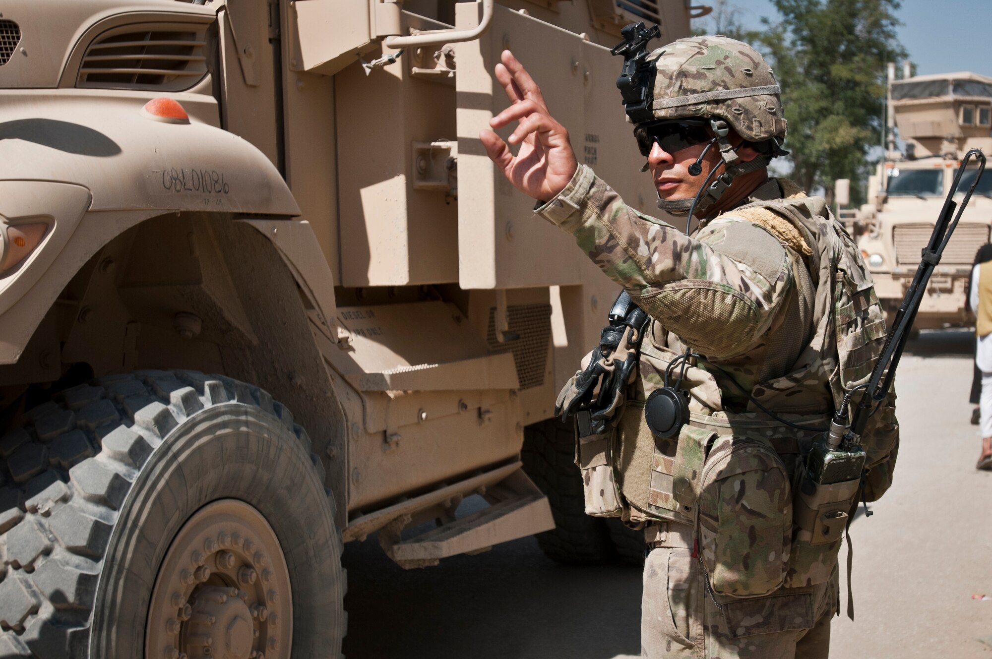 An Airman with the 455th Expeditionary Security Forces Squadron directs vehicles after a successful equipment delivery and meeting with the Afghan National Police at the ANP Bagram district headquarters outside Bagram Airfield, Afghanistan, Sept. 22, 2012. 455 ESFS is responsible for maintaining security on and around BAF to ensure safe operations. (U.S. Air Force photo/SMSgt Dale Canofari)