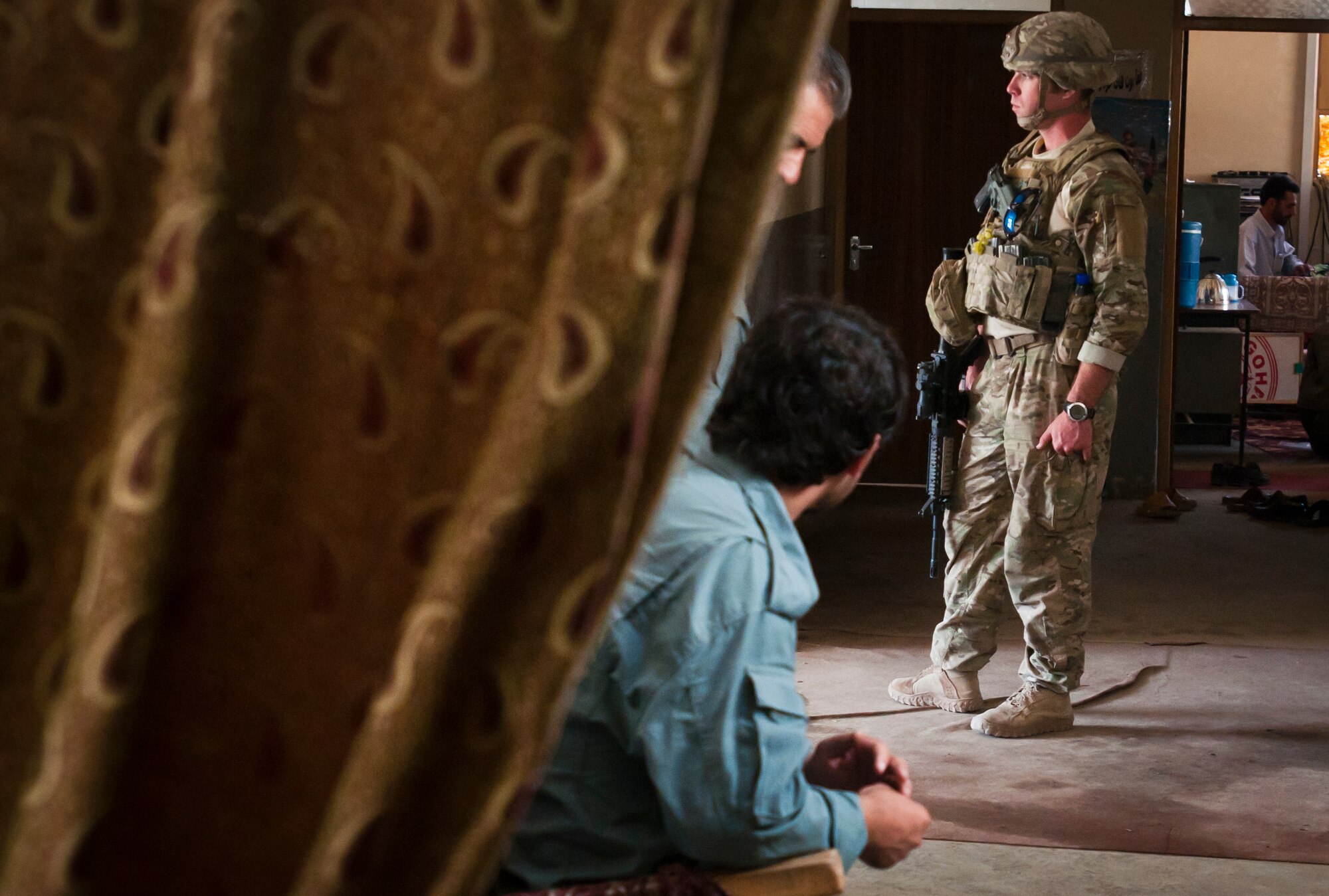 Afghan National Police officers and Airmen with the 455th Expeditionary Security Forces Squadron stands guard during a meeting between U.S. Air Force Lt. Col. Thomas Sherman, 455 ESFS commander, and ANP Col. Haji Azmery, Bagram District Police Chief, at the Bagram District Police headquarters outside Bagram Airfield, Afghanistan, Sept. 22, 2012. Sherman and Azmery met to discuss security operations around Bagram. (U.S. Air Force photo/SMSgt Dale Canofari)